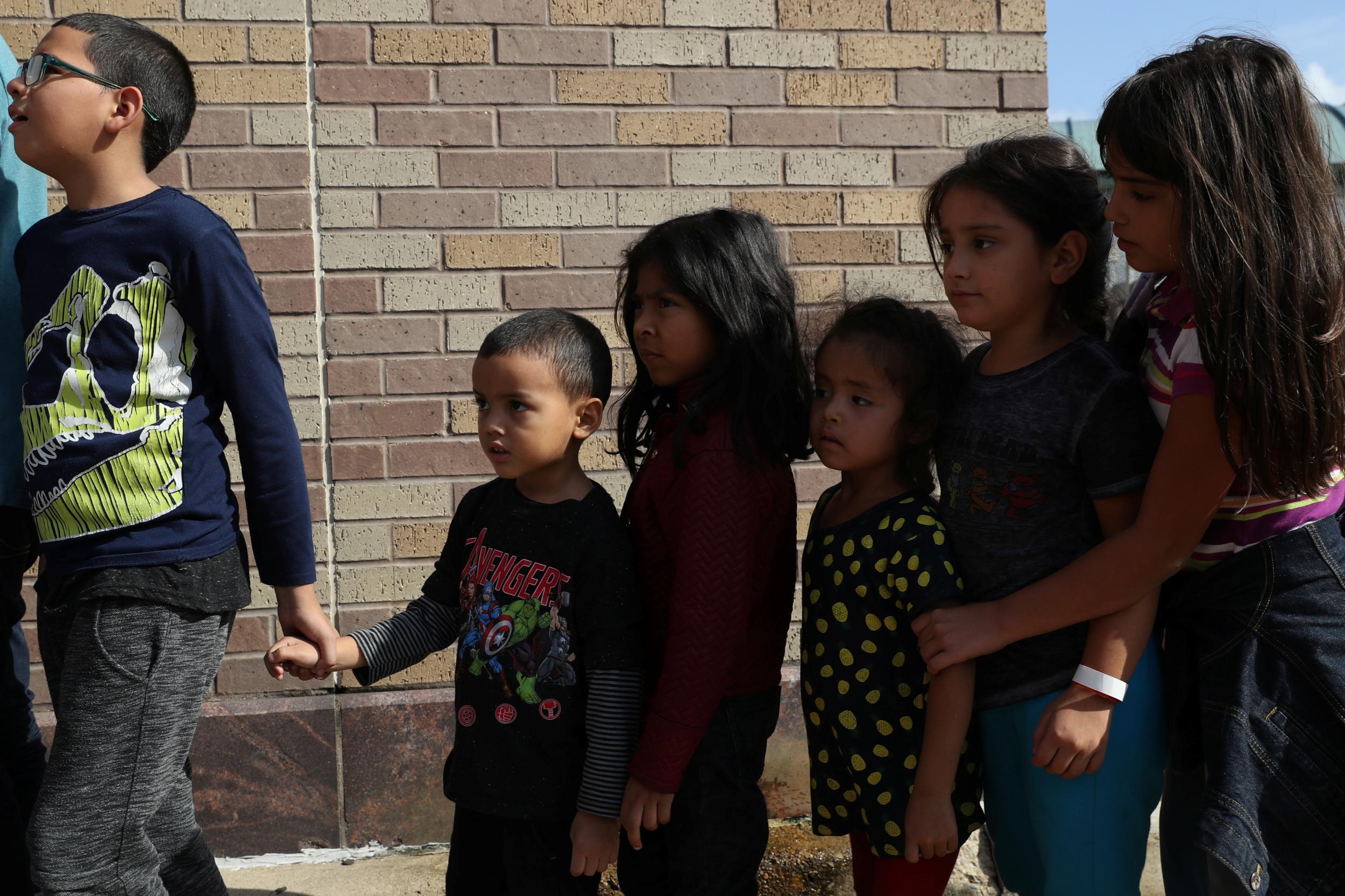 Children form a line as undocumented immigrant families are released from detention at a bus depot in McAllen, Texas, U.S., June 22, 2018.