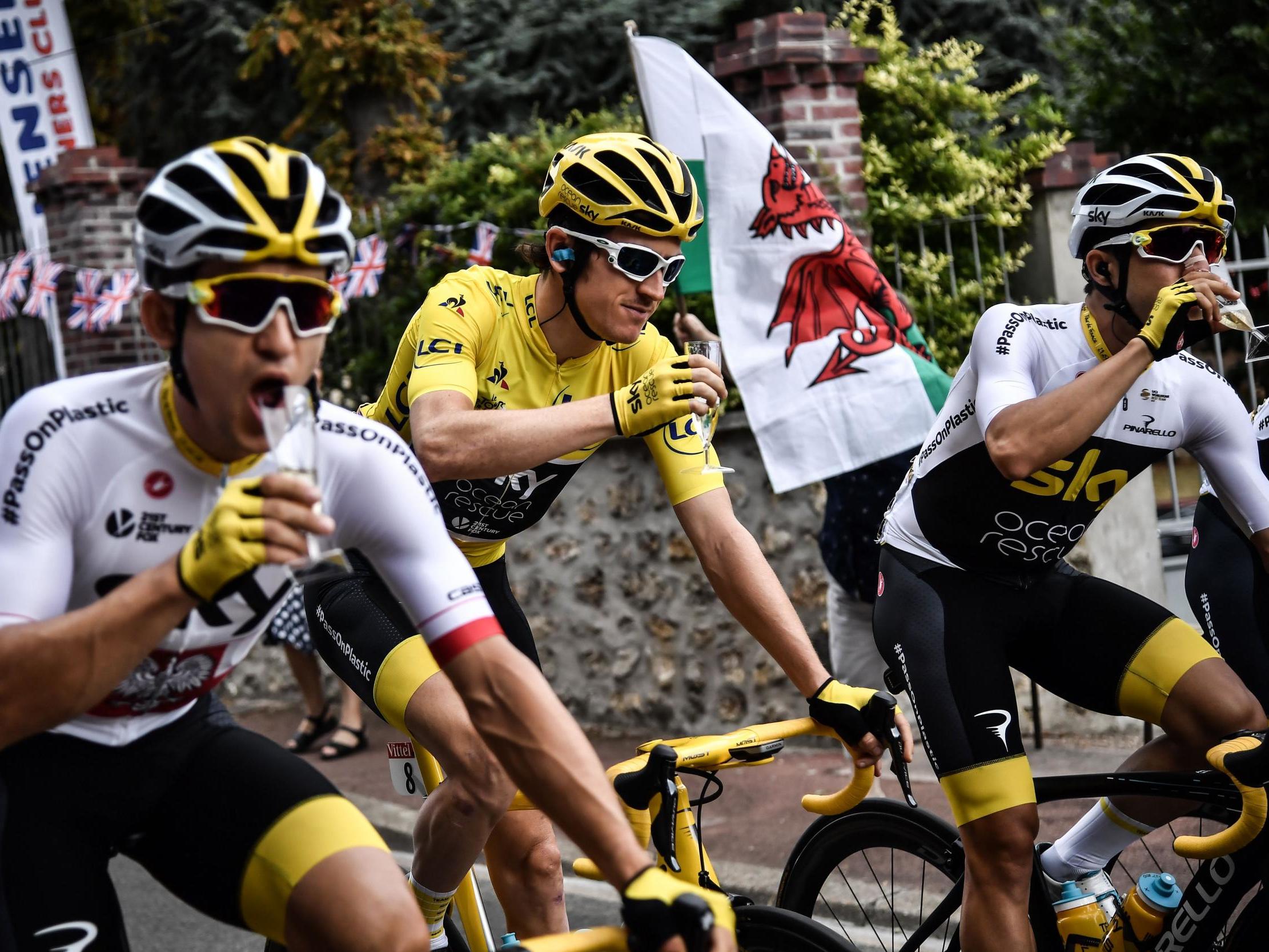 Geraint Thomas celebrates with champagne alongside team-mates