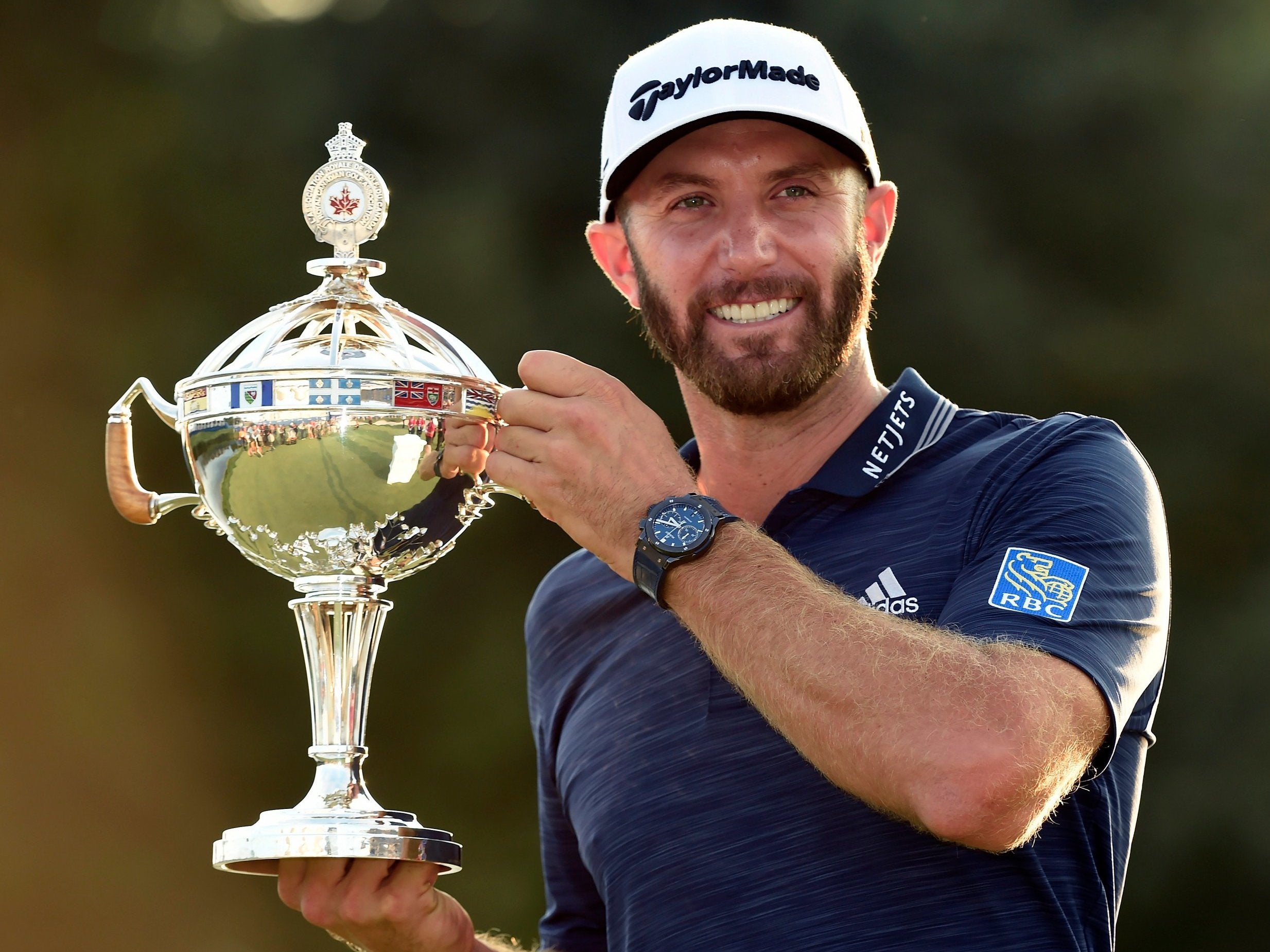 Dustin Johnson celebrates winning the Canadian Open to bag his third title of the year