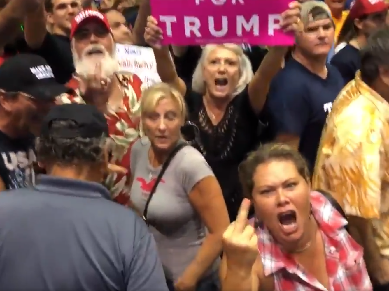 Trump supporters at a rally jeer and hurl abuse at journalists