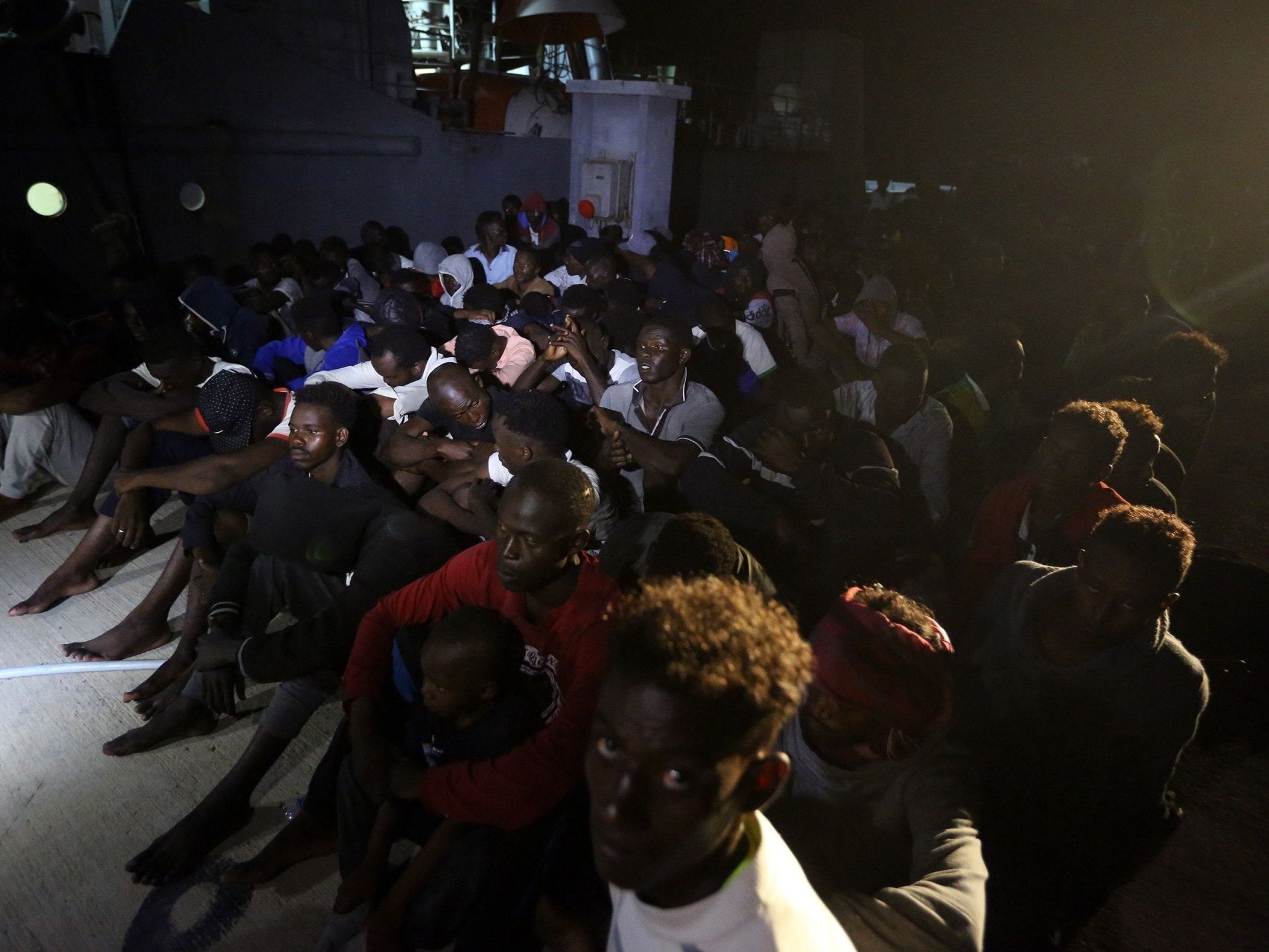 Refugees arrive at a naval base in Tripoli after being rescued off the coast of Zaiwa, around 45km west of the Libyan capital