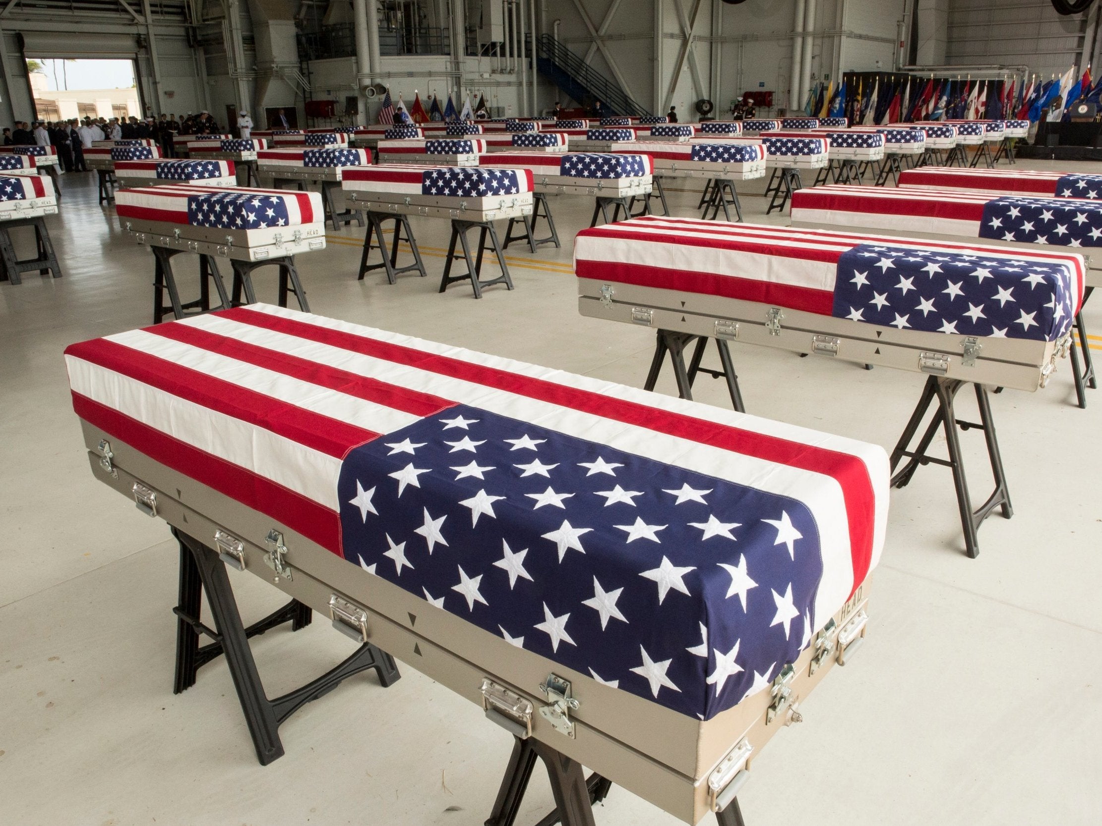 The presumed remains of US soldiers in 55 caskets draped with American flags