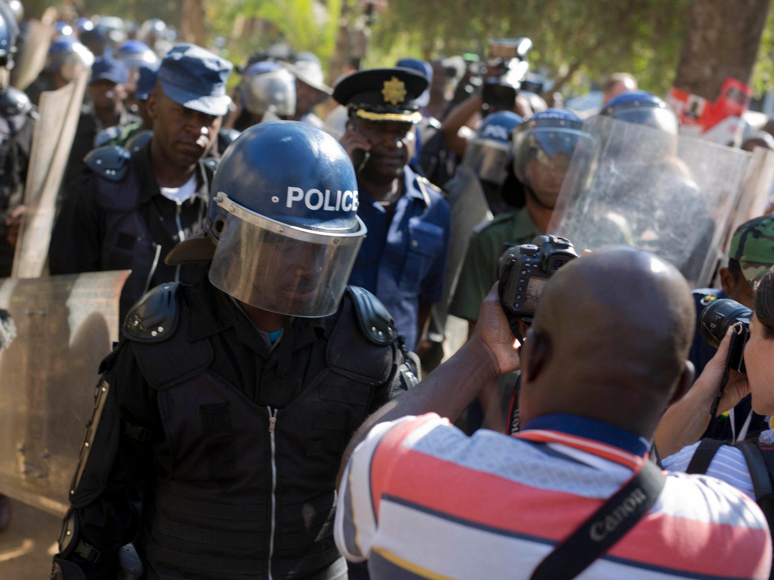 Riot police enter the Bronte hotel in Harare, where a press conference by Chamisa was scheduled to take place