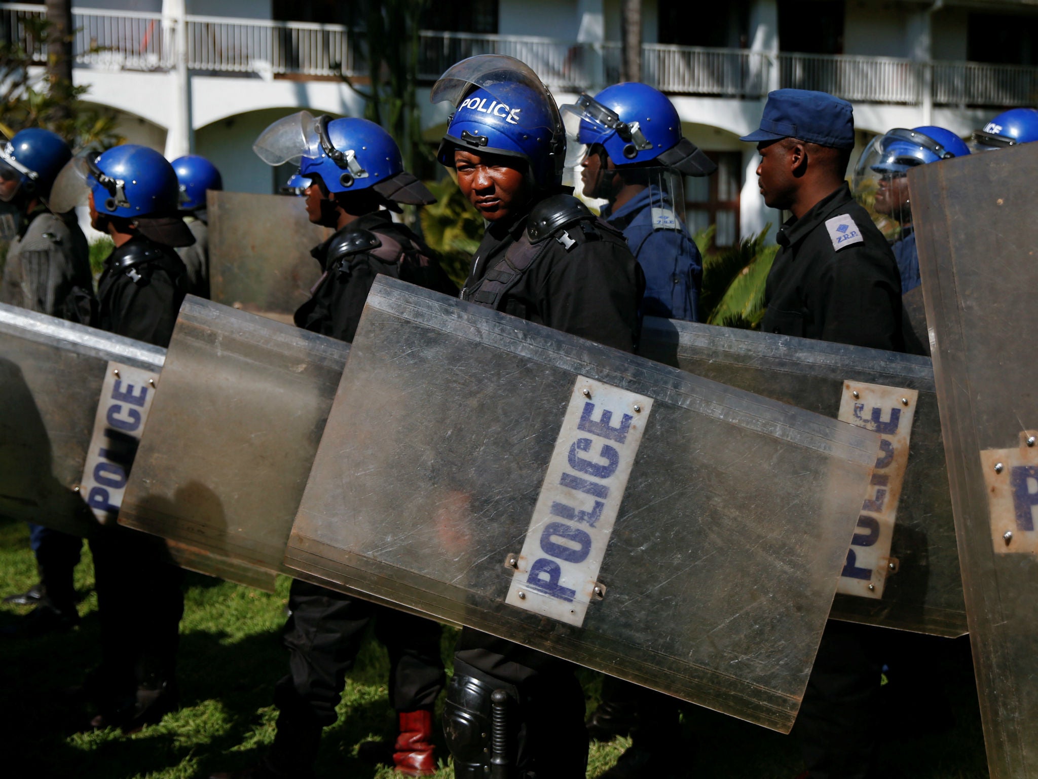 Riot police arrive at a press conference due to be addressed by opposition party leader Nelson Chamisa