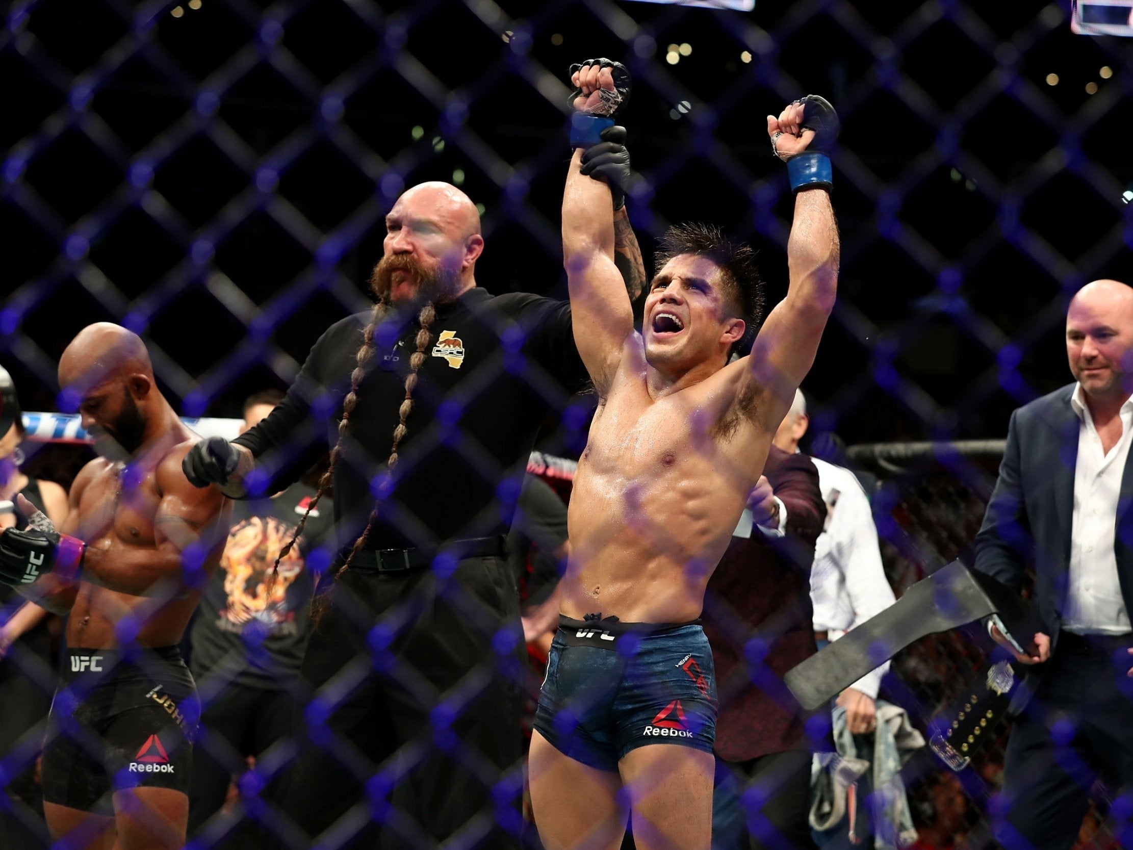 Henry Cejudo celebrates winning the UFC flyweight championship with victory over Demetrious Johnson