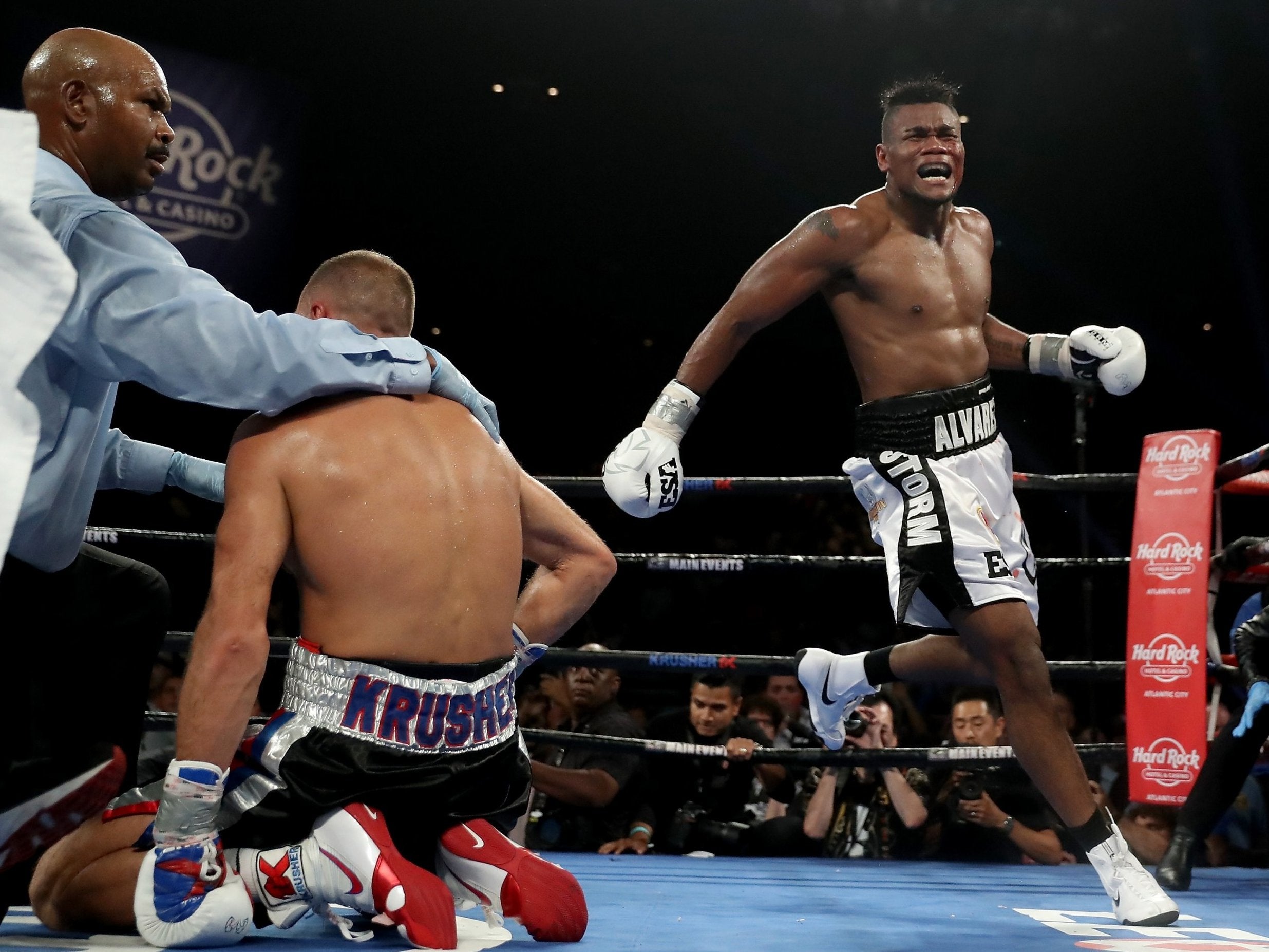 Elieder Alvarez celebrates as the referee tends to Sergey Kovalev