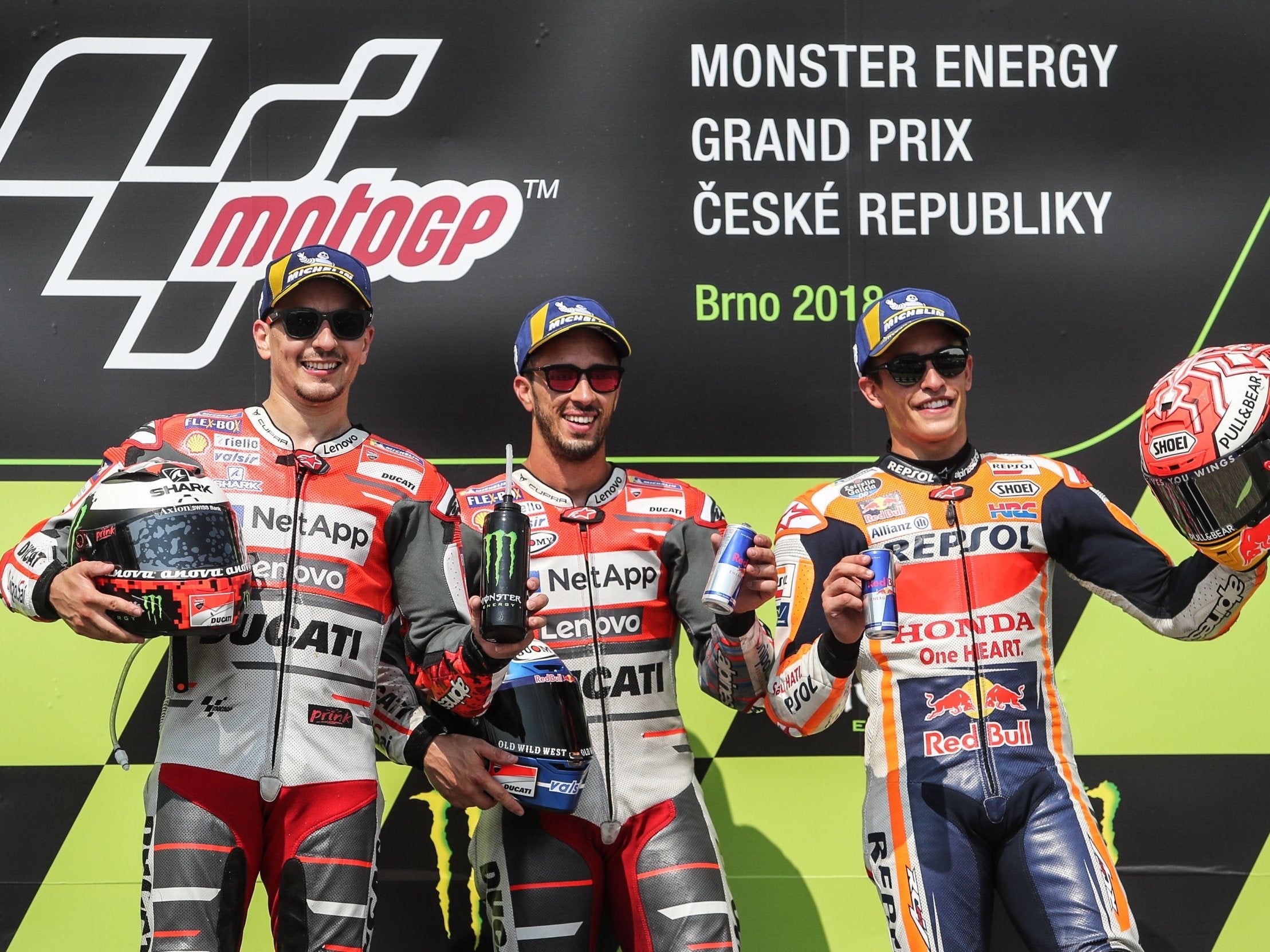 Dovizioso (centre) celebrates his victory over Lorenzo (left) and Marquez (right)