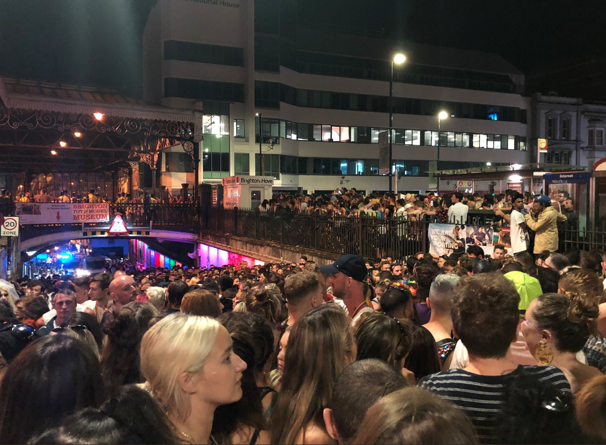 Partygoers wait outside Brighton train station.