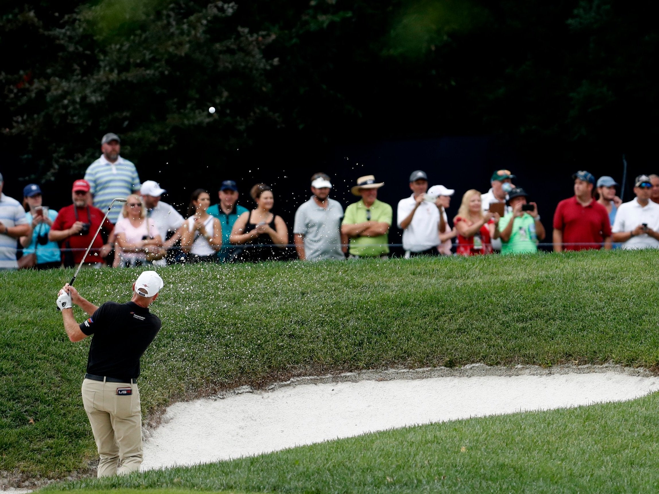 Jim Furyk hits out of a bunker at Bellerive