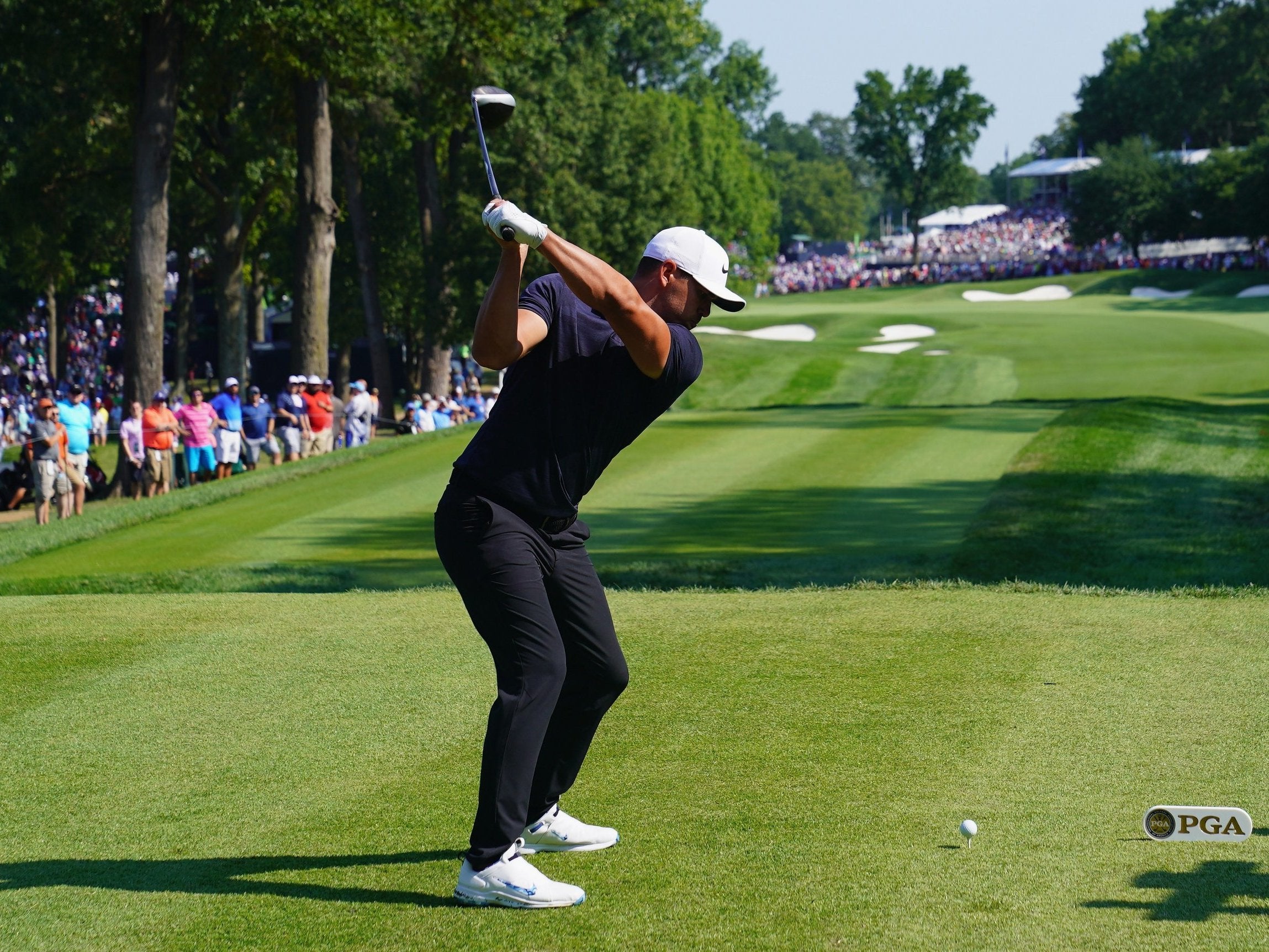 Brooks Koepka plays his tee shot at the 18th