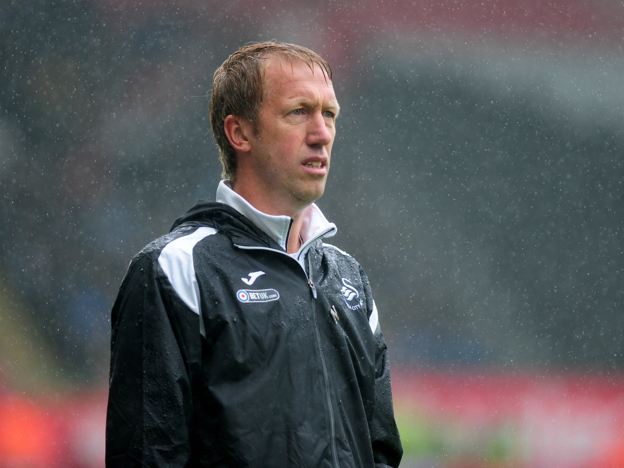 Potter withstands the rain as he watches Swansea's victory over Preston