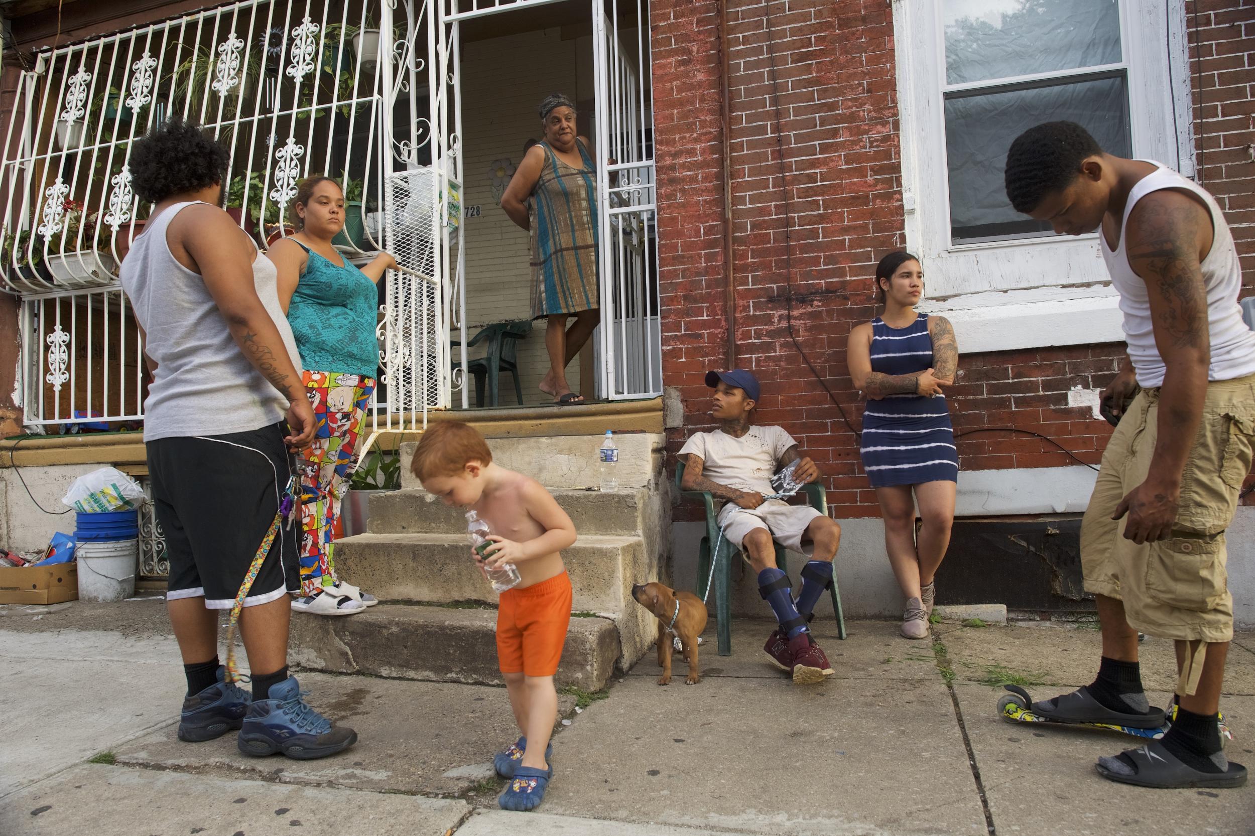 People congregate on a rowhouse stoop in the historically Puerto Rican Hunting Park neighbourhood in North Philadelphia