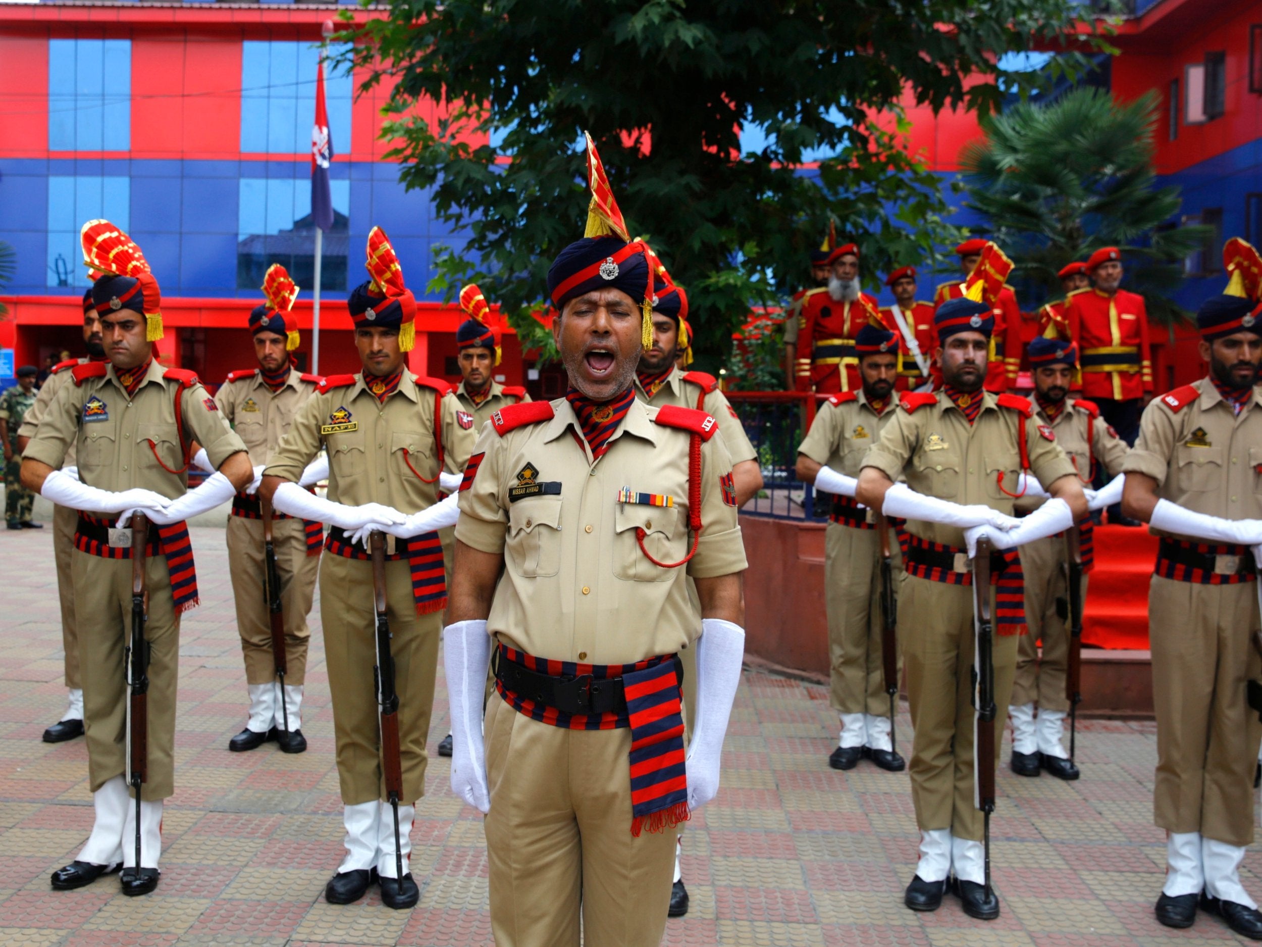 Indian policemen pay tribute near the coffin of their slain colleague, Parvaiz Ahmad, during a ceremony in Srinagar, the summer capital of Indian Kashmir