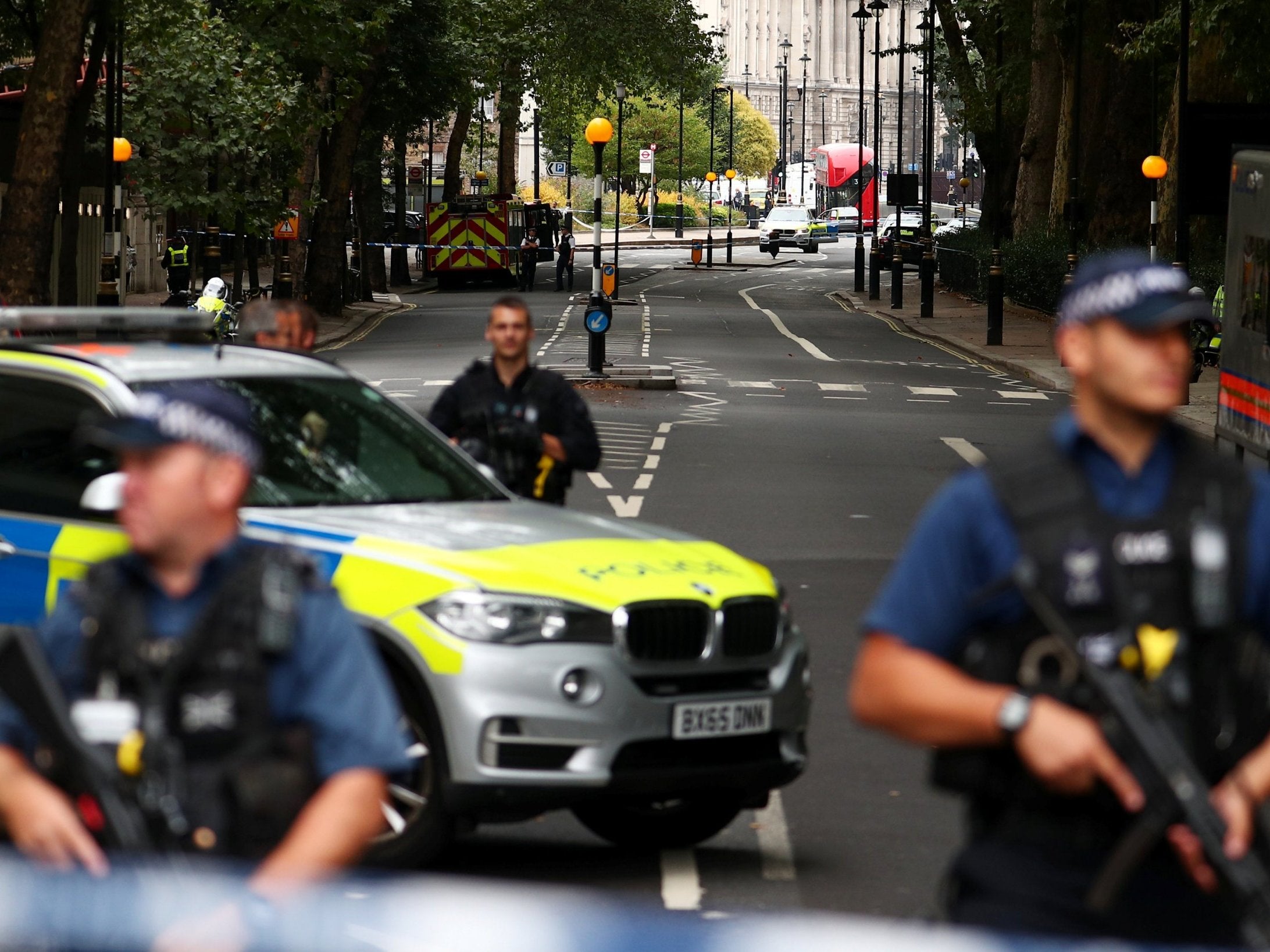 Armed police officers stand at a cordon after a car crashed outside the Houses of Parliament in Westminster Reuters)