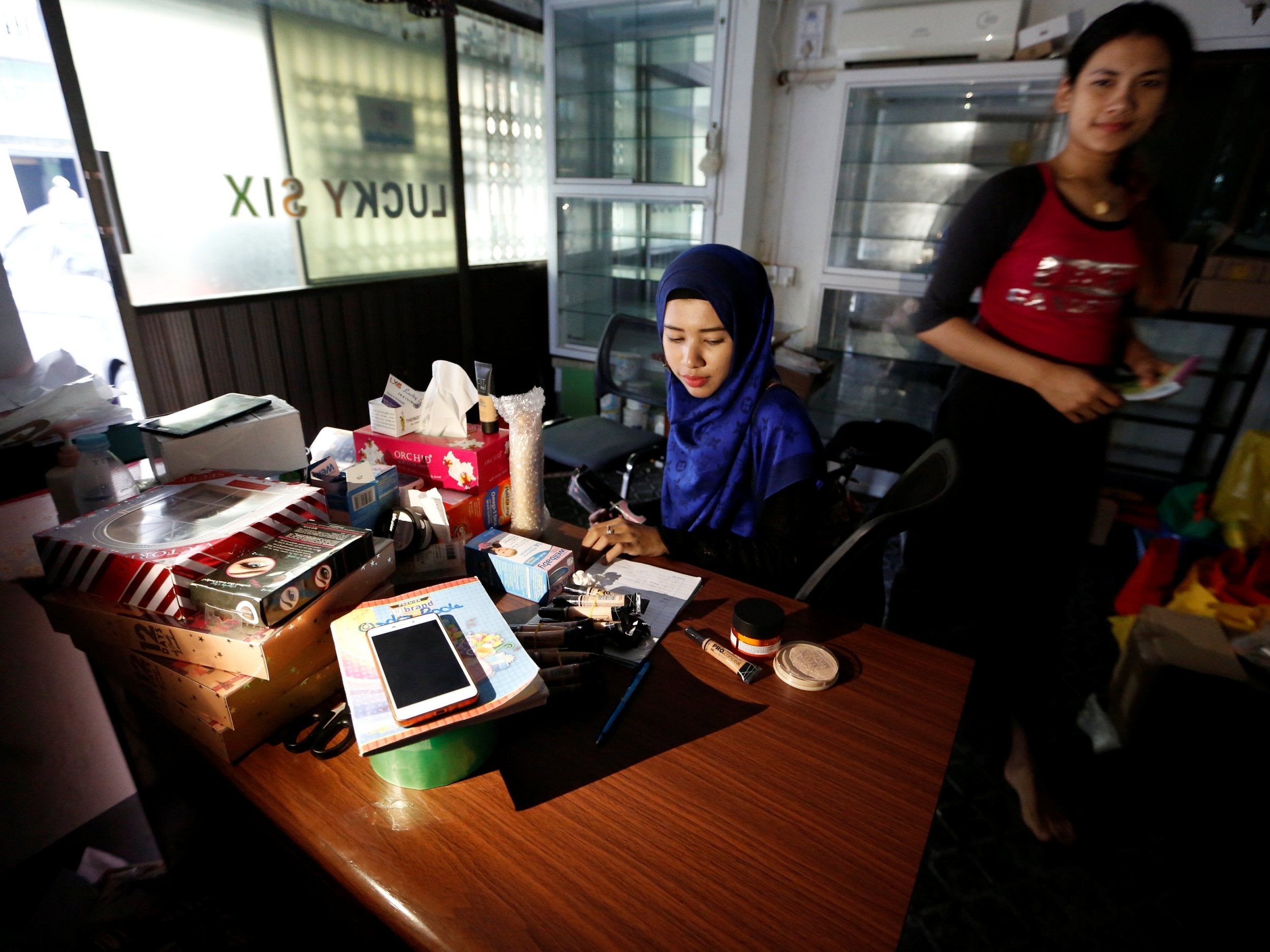 Wie Lae Phyu Sin buys makeup in Yangon, Myanmar