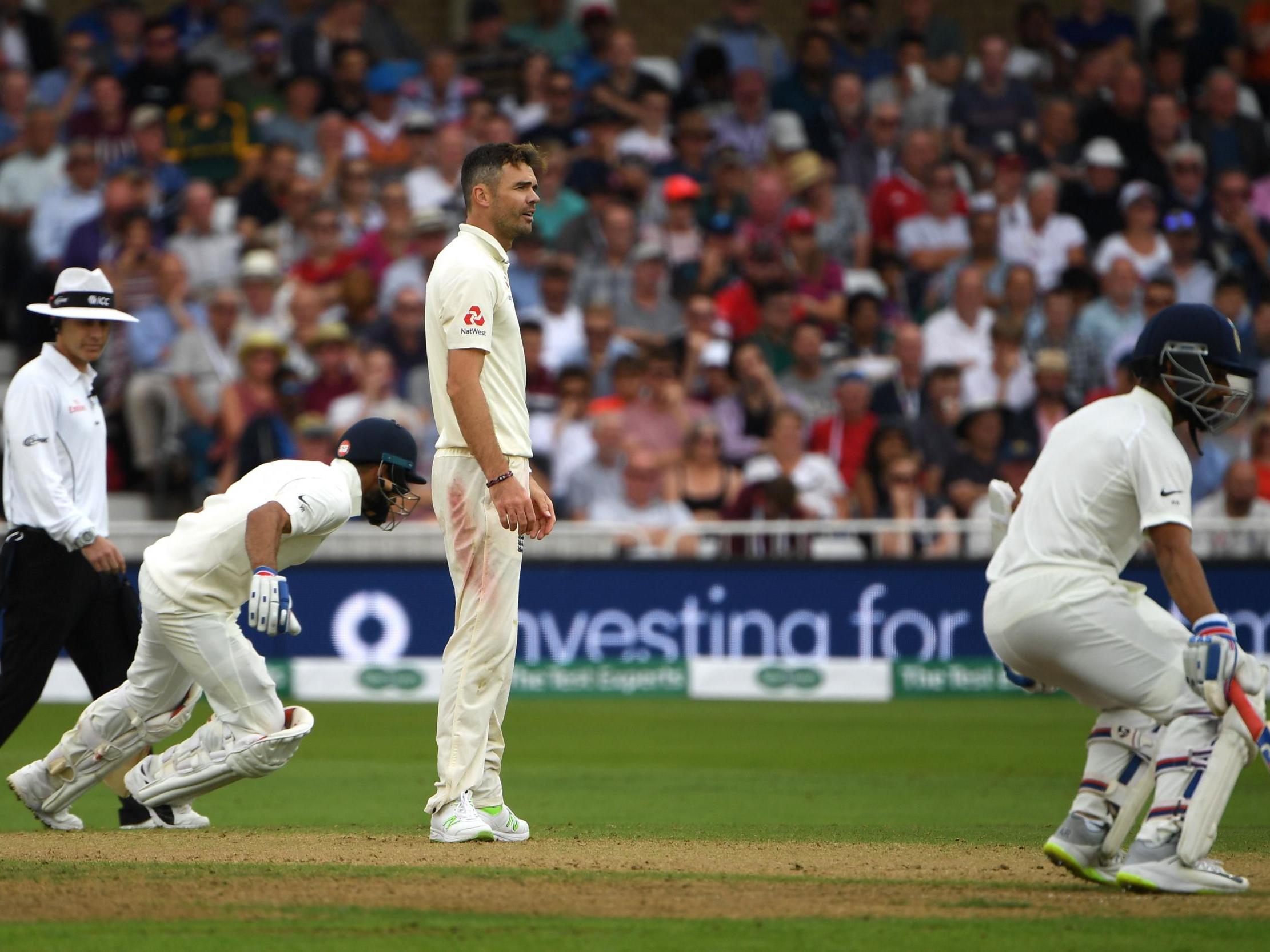 Ajinkya Rahane and Virat Kohli run between the wickets as James Anderson watches on