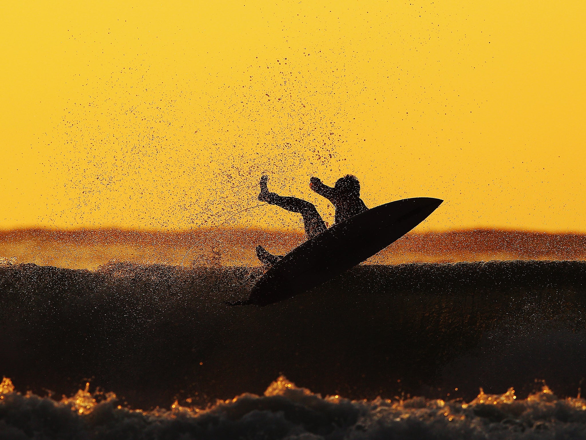 Police say surfers were confronted by two people on the bank, who began shouting abuse at them