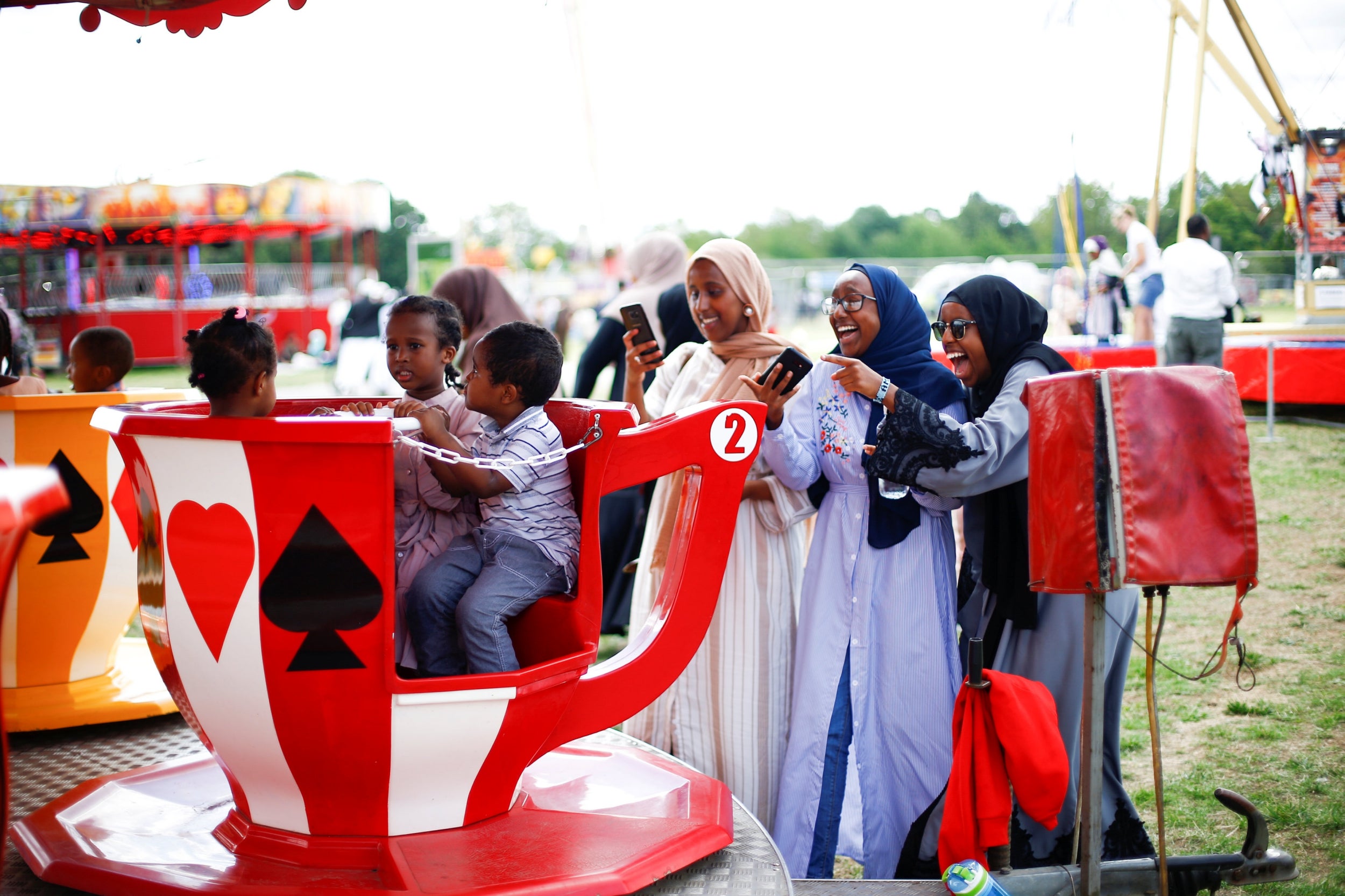 People at a fairground set up celebrate Eid Al-Adha in Burgess Park, south London