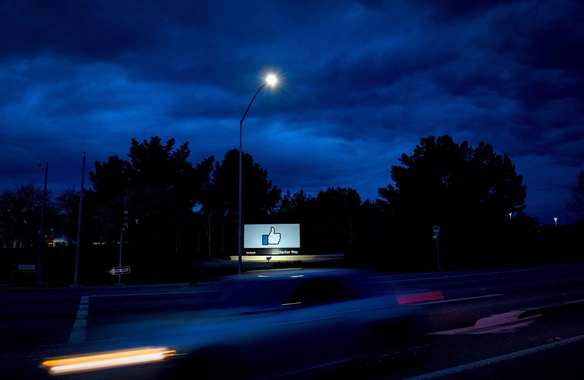 A car passes by Facebook's corporate headquarters location in Menlo Park, California, on March 21, 2018