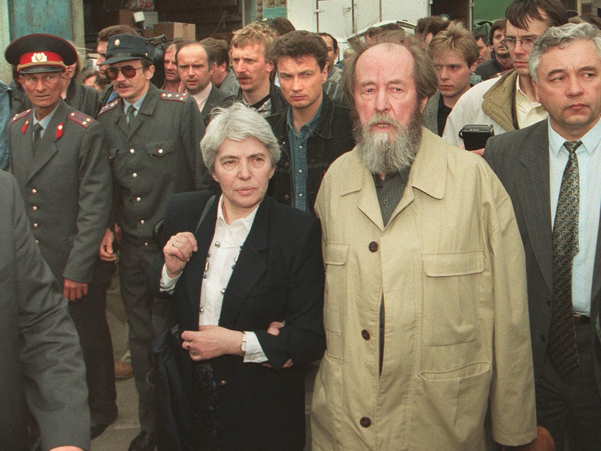 Solzhenitsyn and his second wife Natalya go for a walk in Vladivostok, surrounded by local militiamen