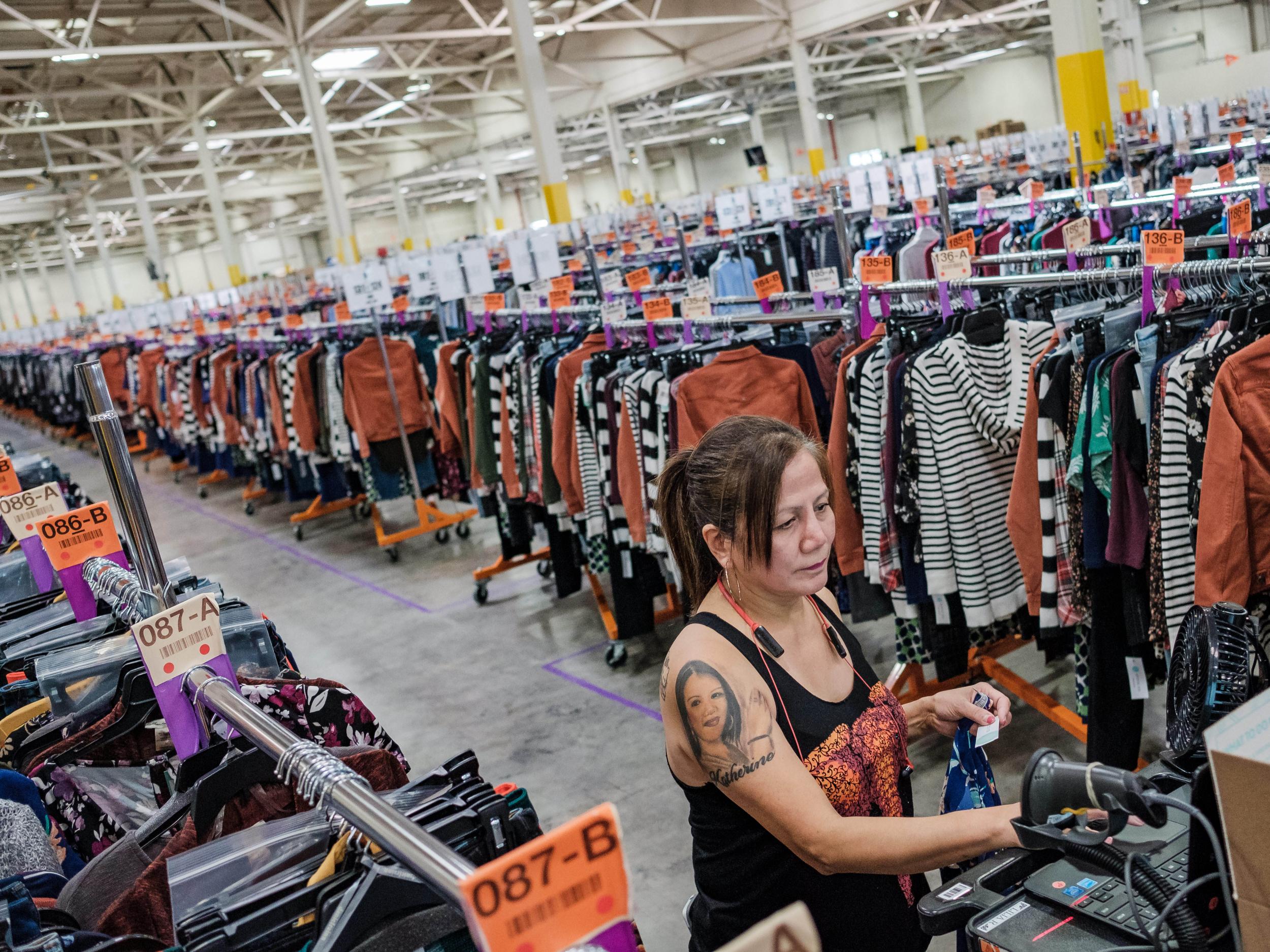 A Stitch Fix warehouse worker packing and dispatching clothing, chosen for customers by a combination of human stylists and computer algorithms