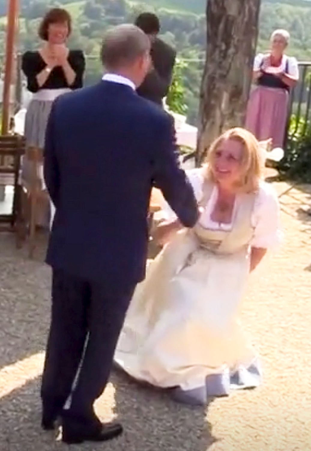 Austria's Foreign Minister Karin Kneissl curtsies to Russian President Vladimir Putin at her wedding in Gamlitz, Austria, August 18, 2018 in this picture grab taken from video.