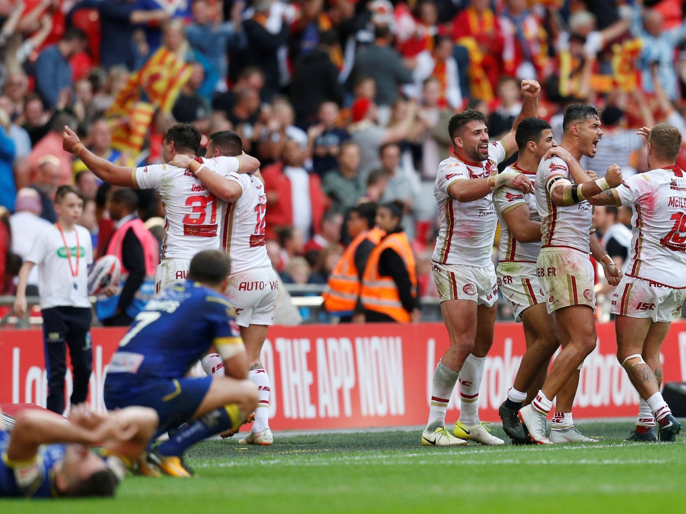 The Catalans Dragons celebrate their victory after the final whistle