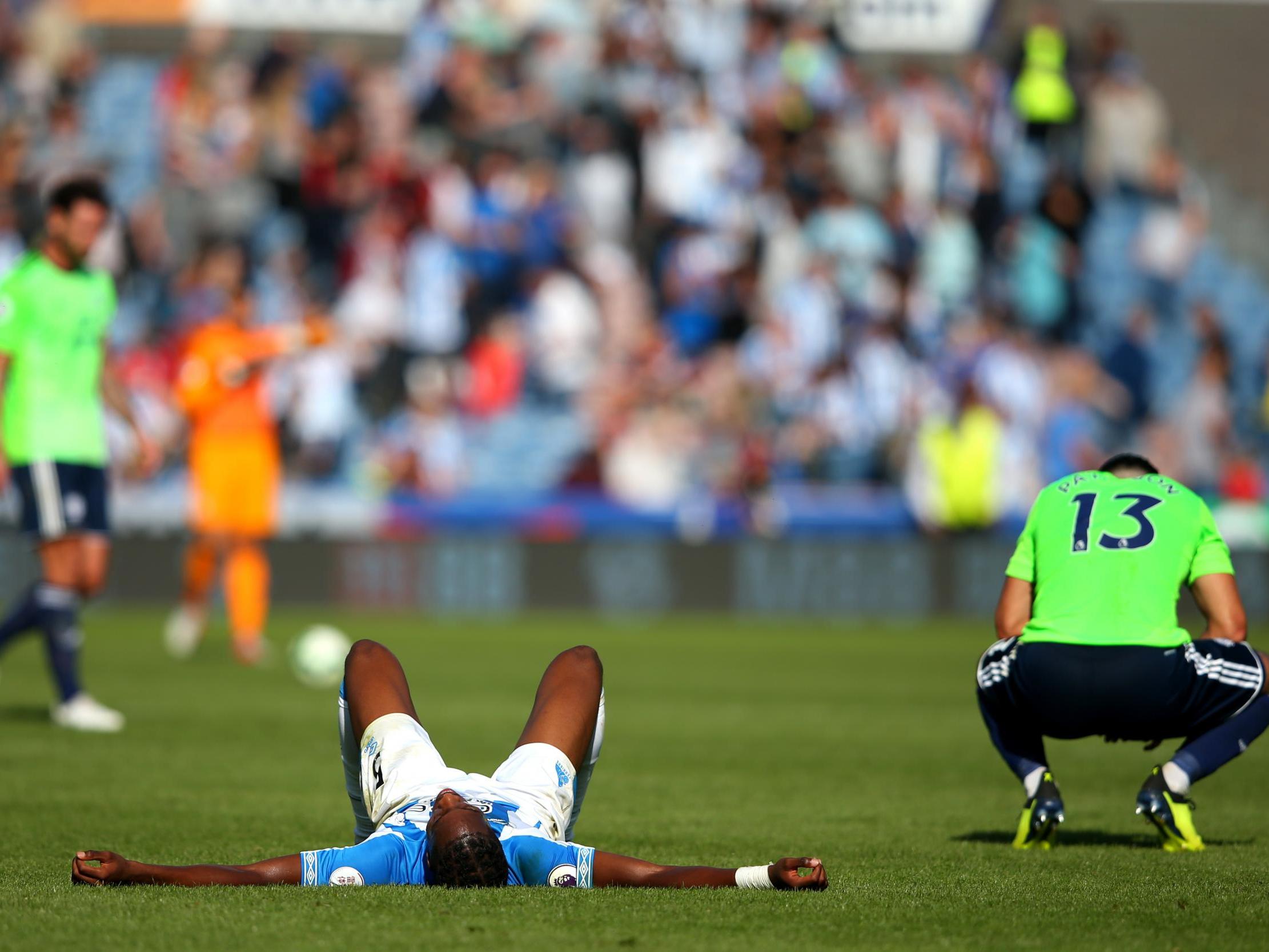 Terence Kongolo and Callum Paterson react after the final whistle