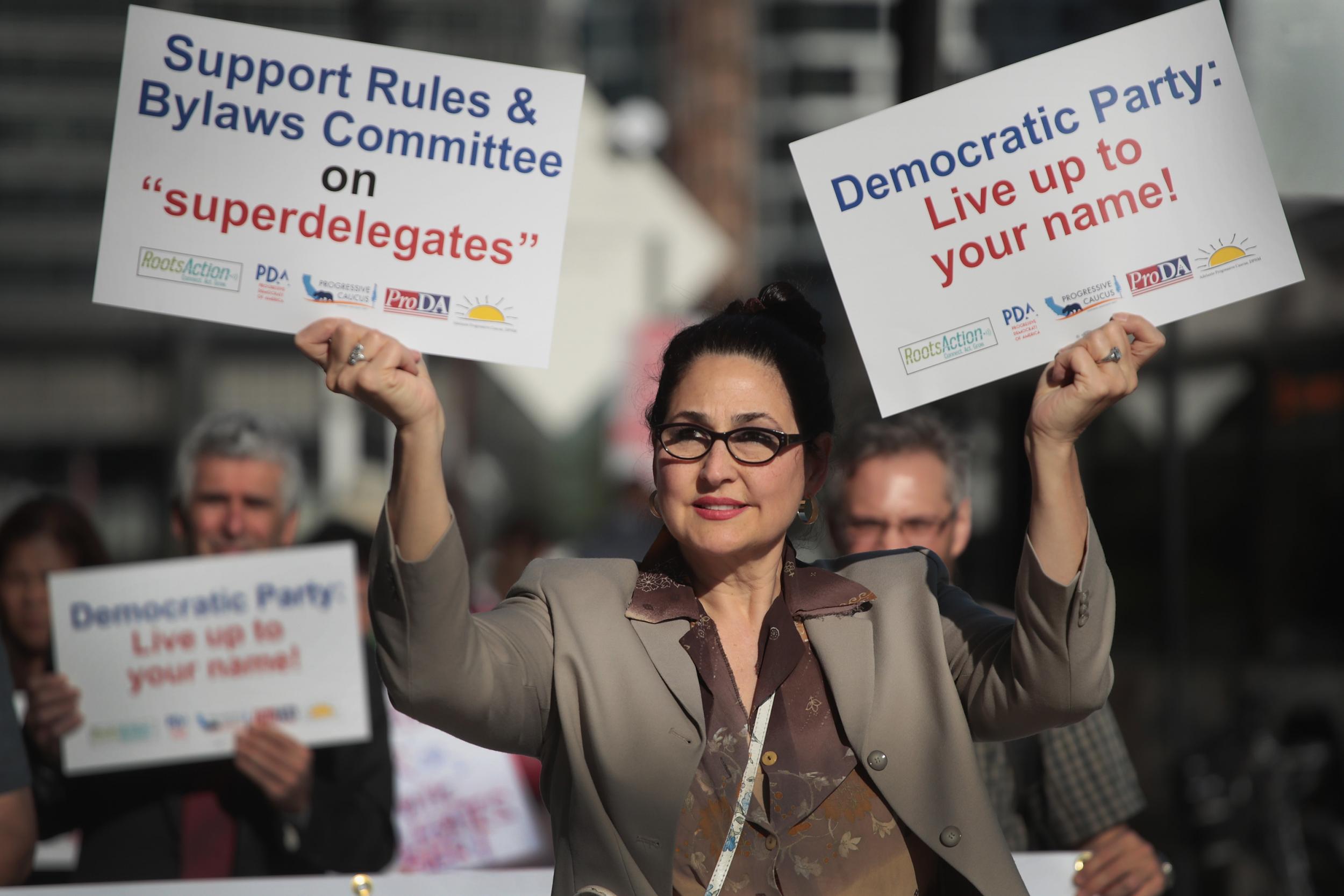 Demonstrators protest outside the Hyatt Hotel where the Democratic National Committee (DNC) were kicking off their summer meeting