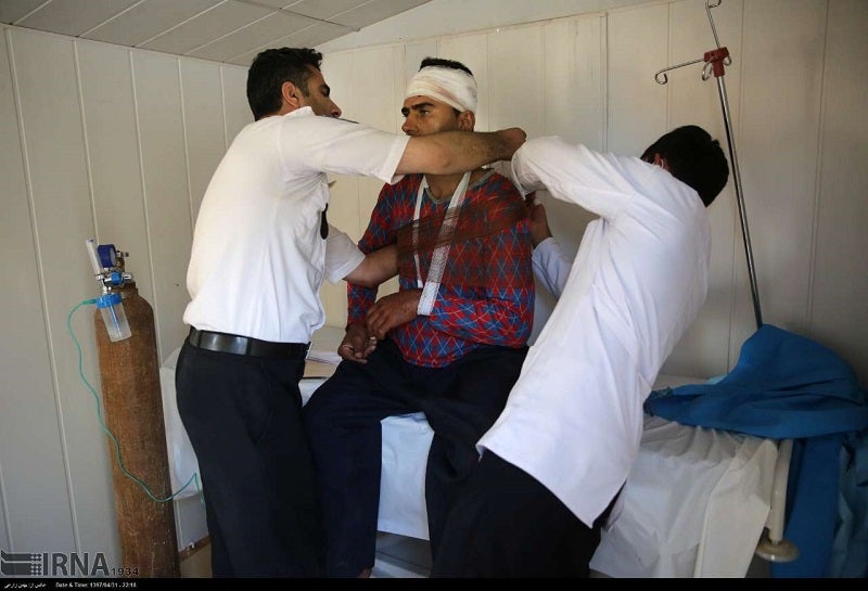 A man is treated by medics following the earthquake.