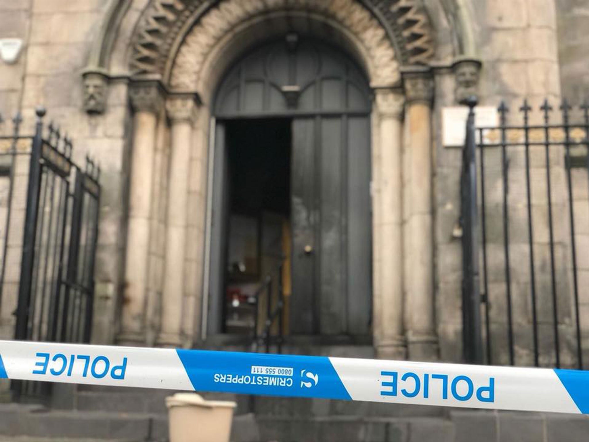 The charred front door of the Guru Nanak Gurdwara in Edinburgh