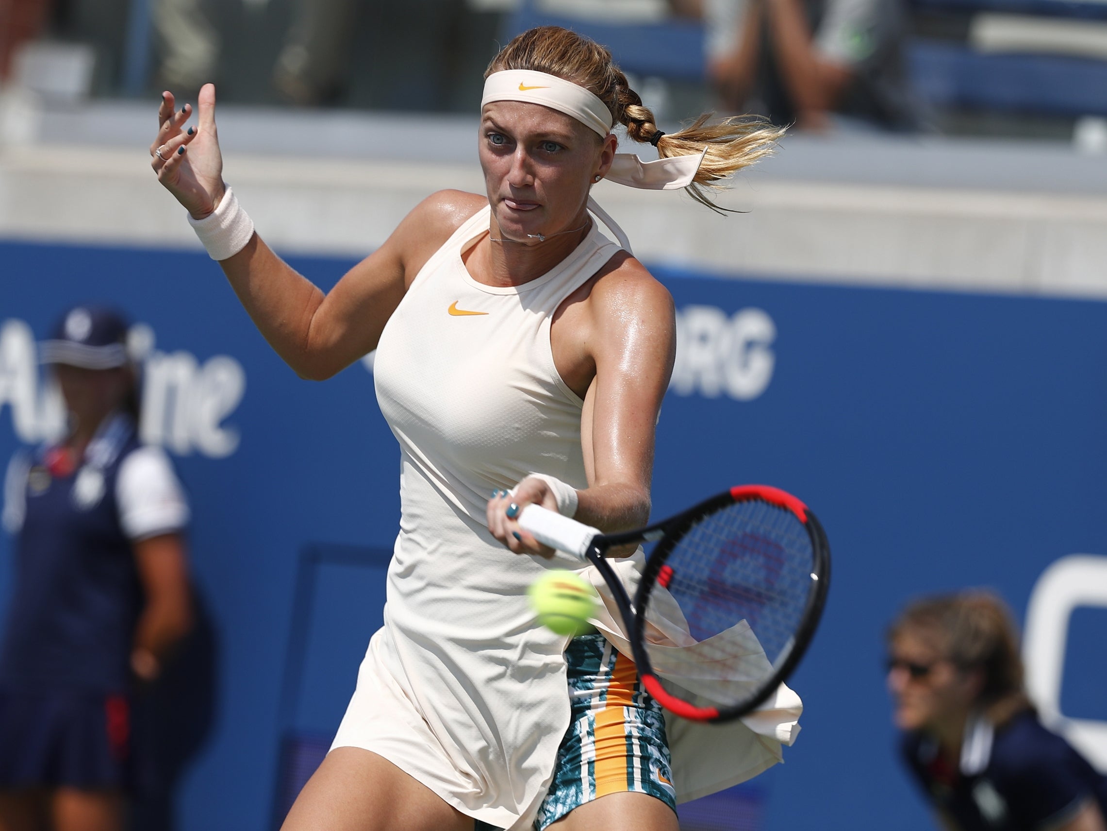 Petra Kvitova hits a return against Yanina Wickmayer