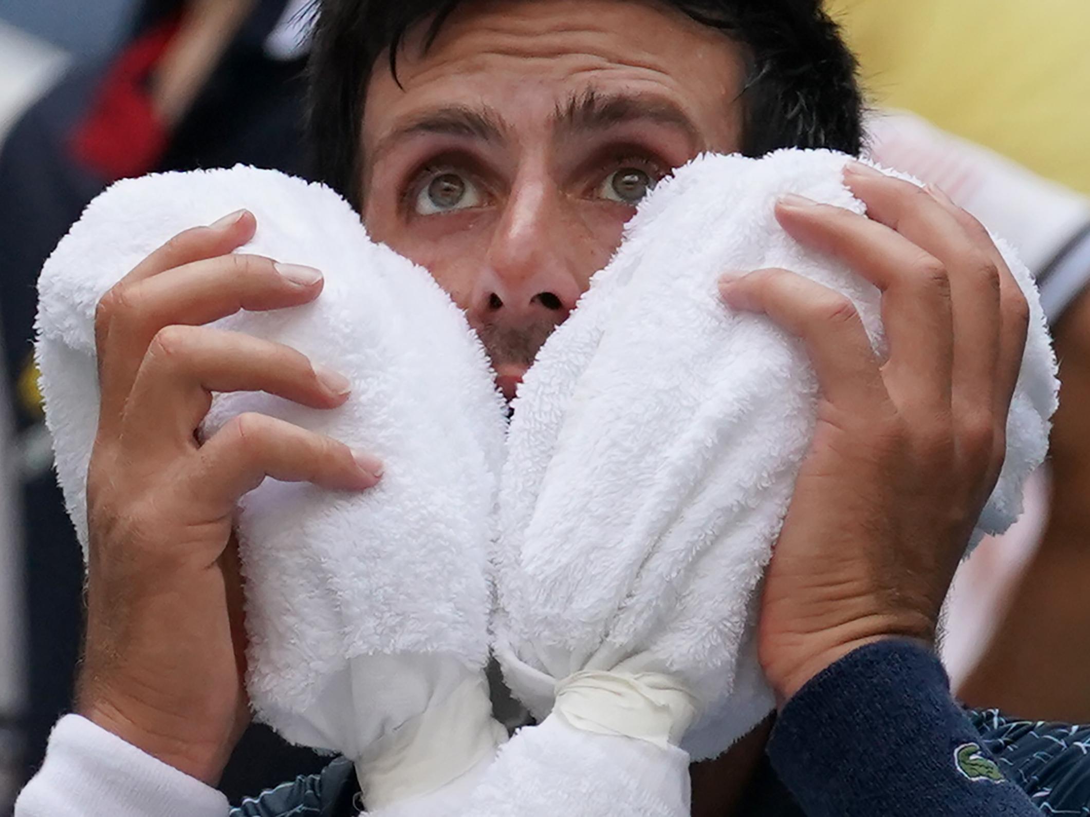 Novak Djokovic cools off between games at the US Open