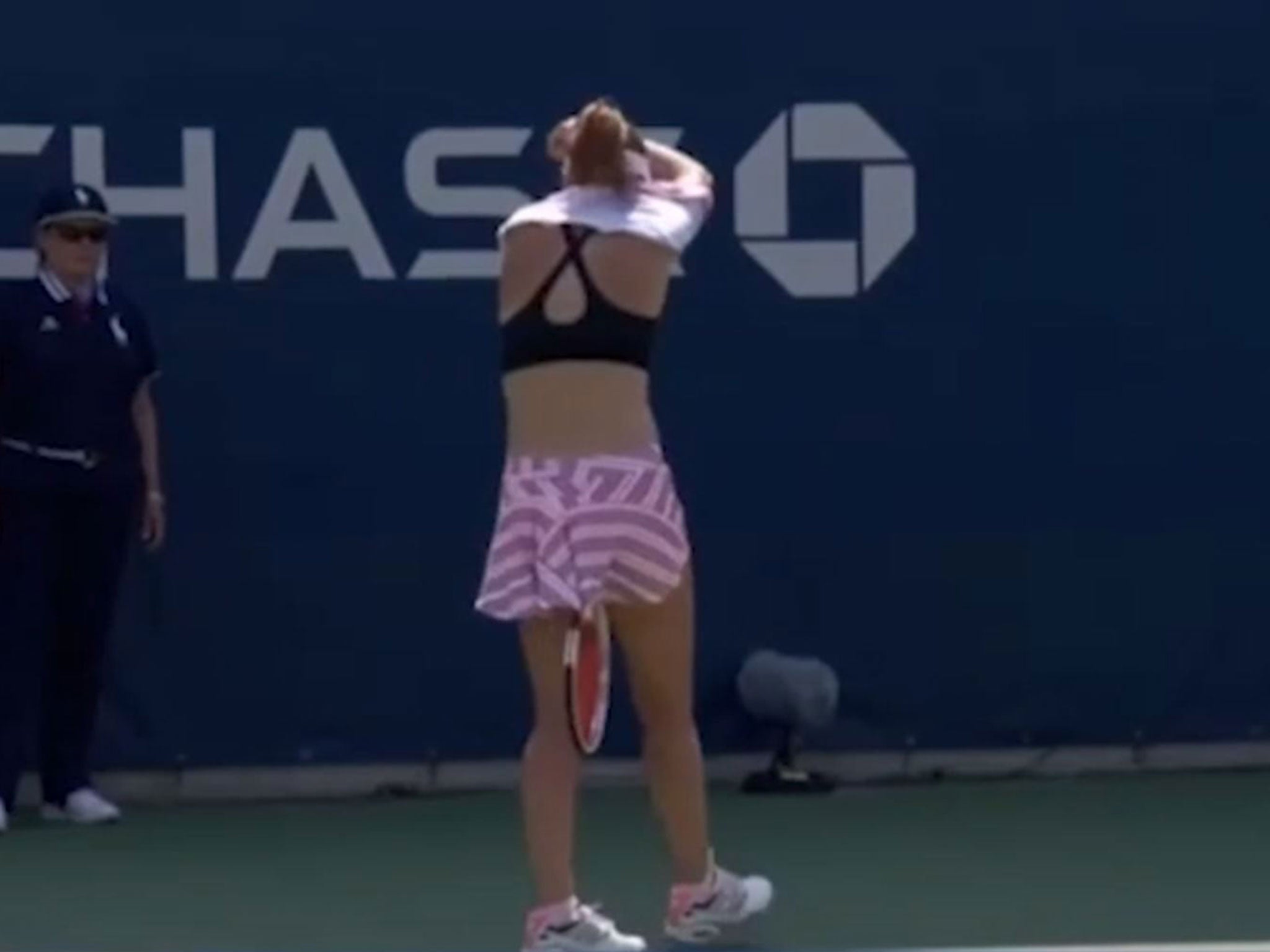 Cornet turned away from the cameras as she removed the top