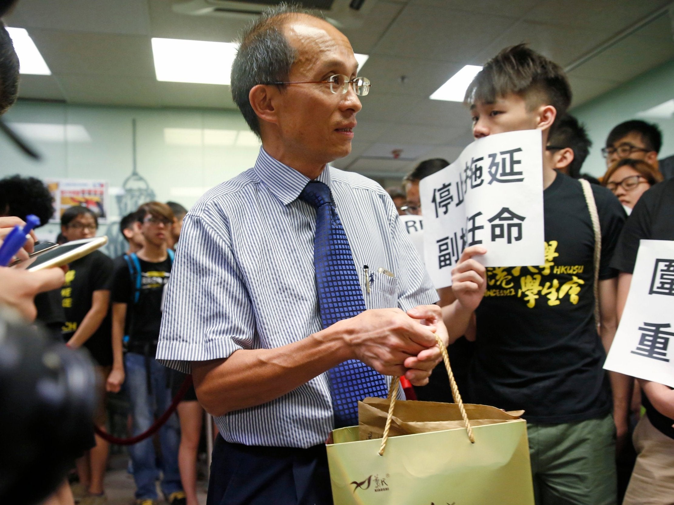 University of Hong Kong Professor, Cheung Kie-chung, center, attends a conference in Hong Kong