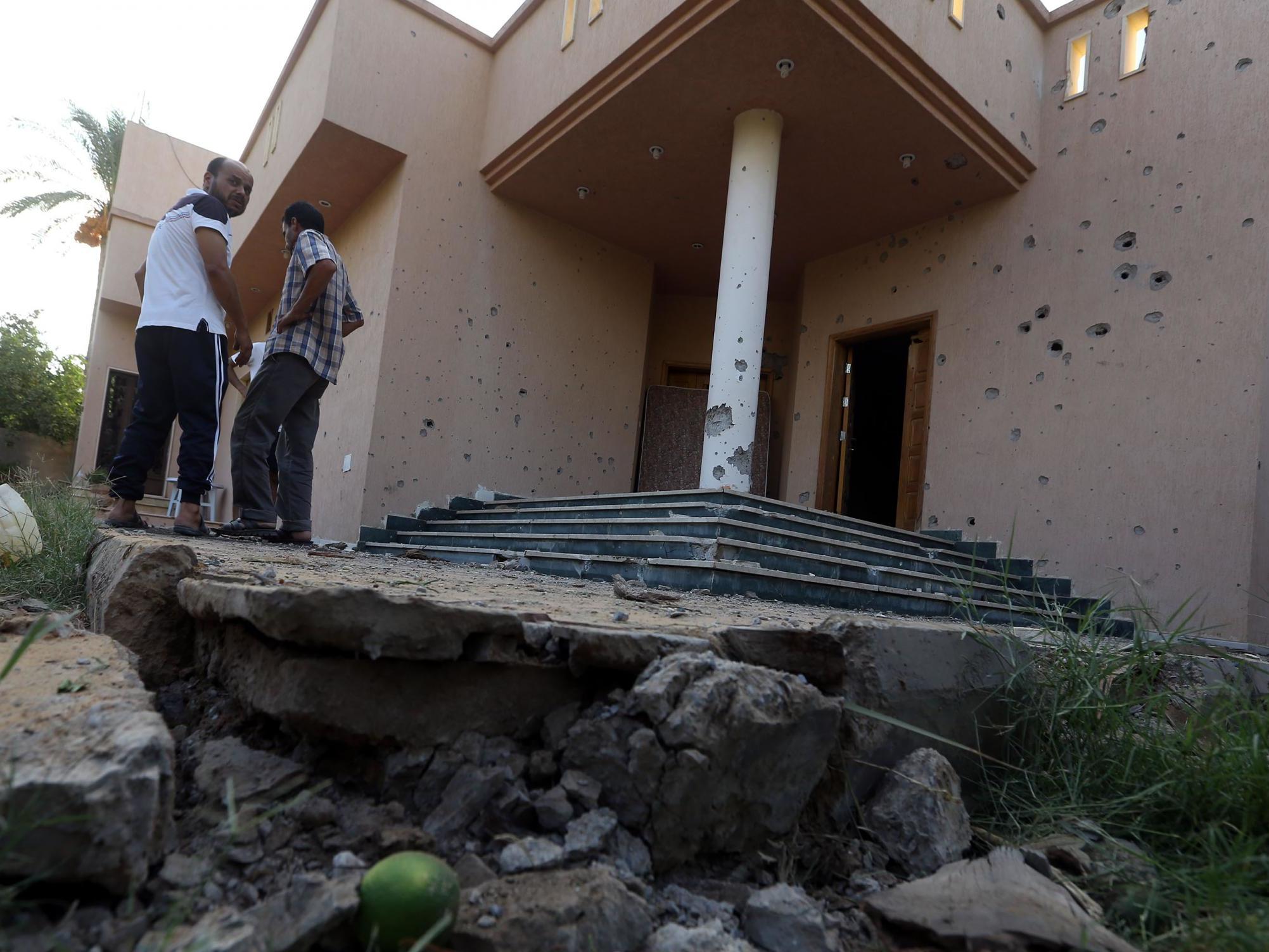 Libyans gather at the site of where a mortar shell landed in the capital