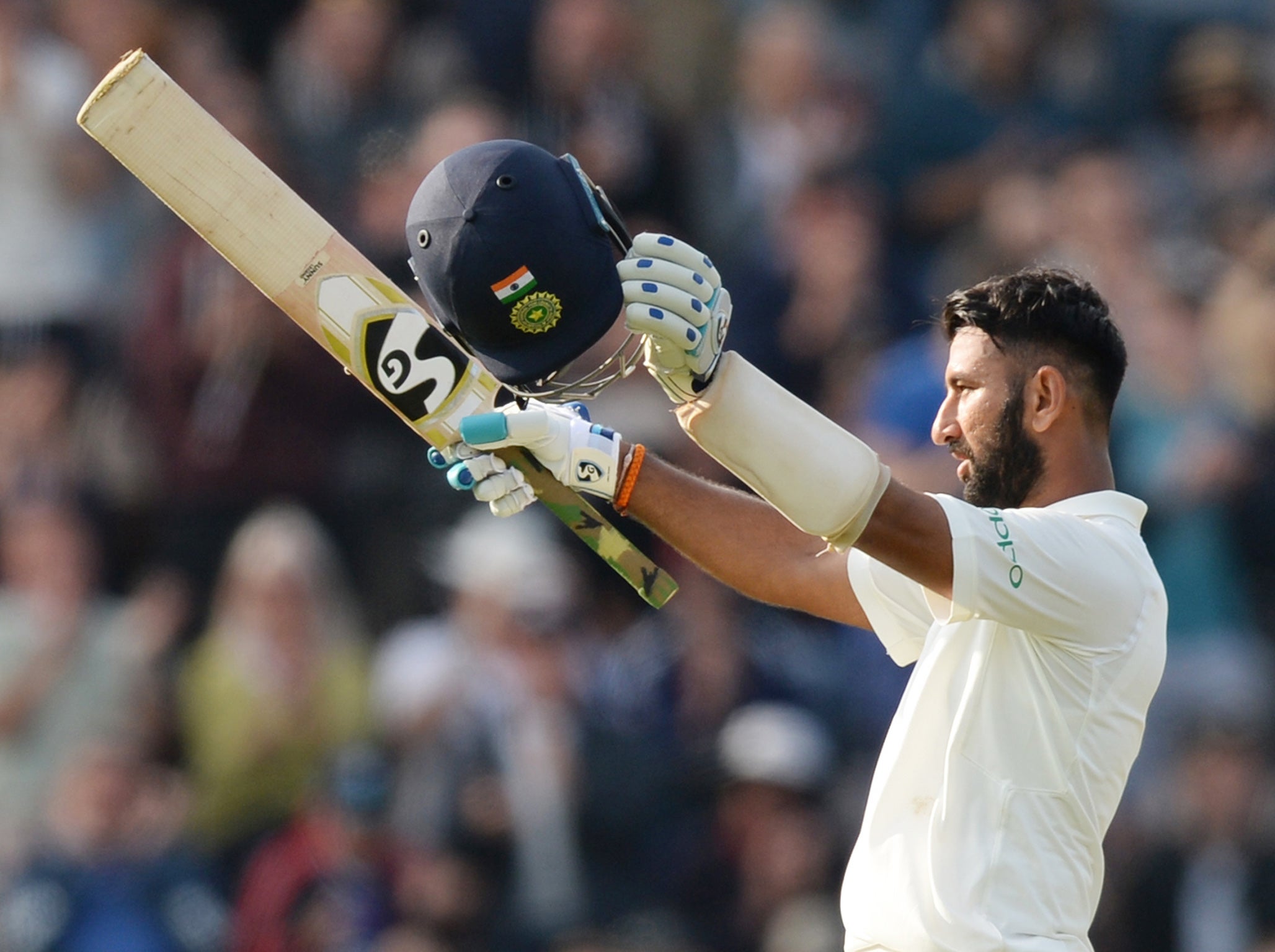 Cheteshwar Pujara of India celebrates reaching his century