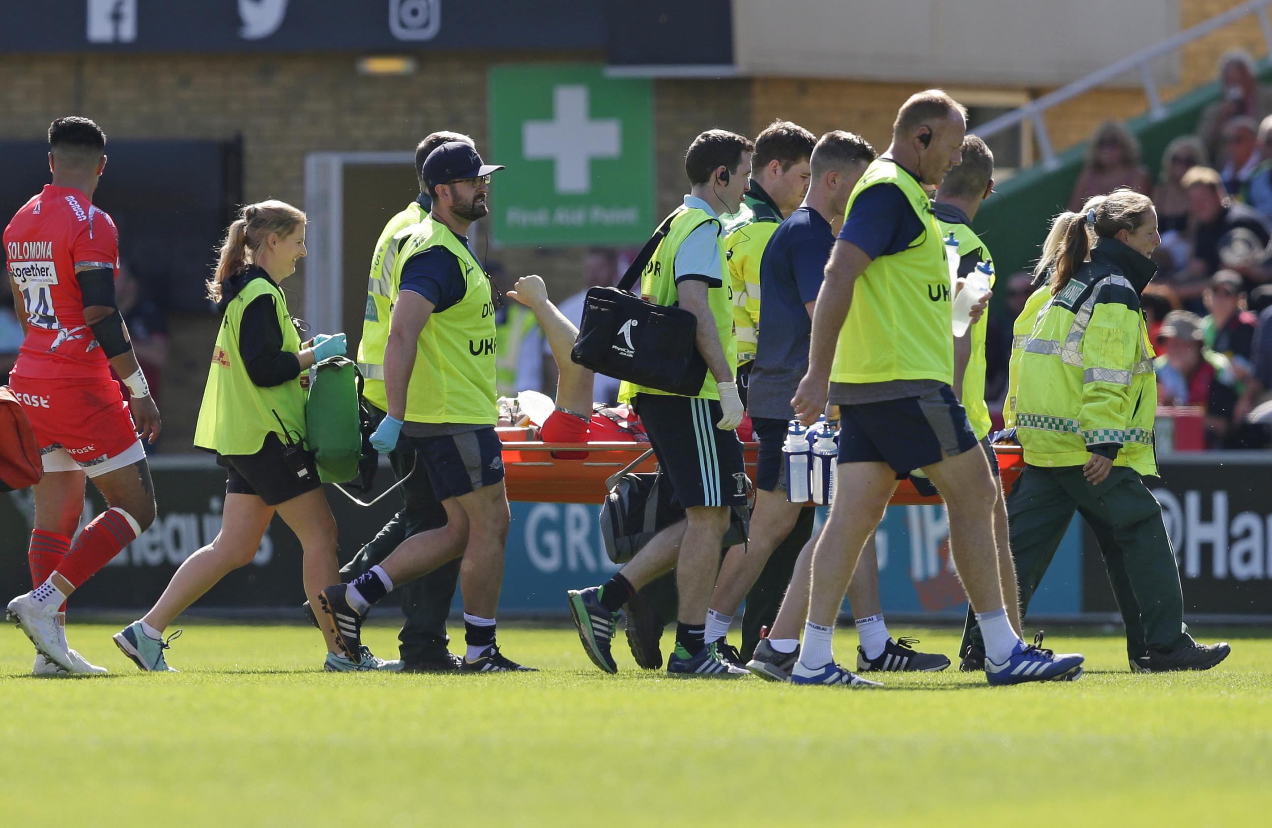 Tom Curry is carried off on a stretcher after injuring his head