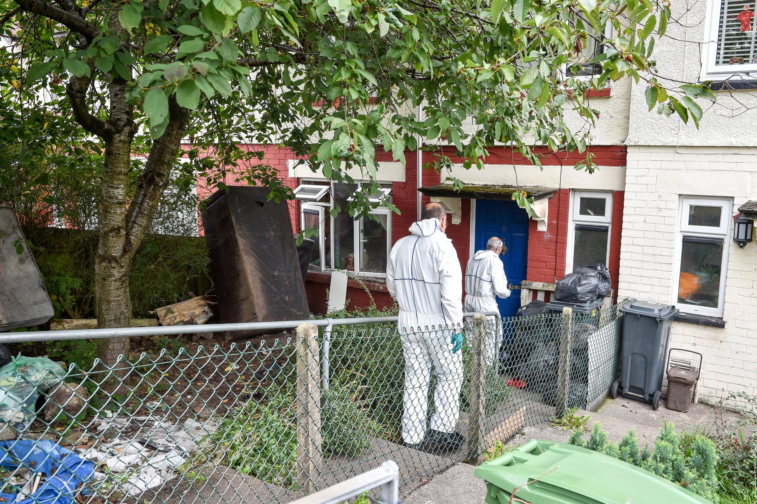 Police forensic officers enter a property on Archer Crescent, Ely, Cardiff, Wales, where Edward John Harris has been charged with explosive offences and possessing terrorist documents.