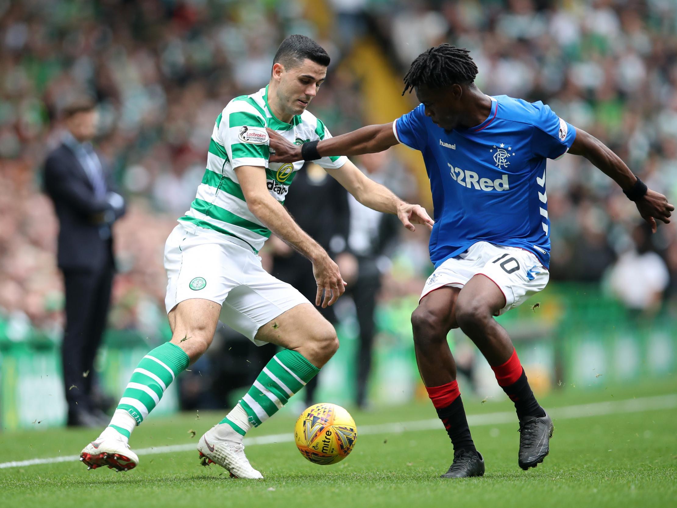 Tomas Rogic and Ovie Ejaria tussle for possession in the Old Firm derby