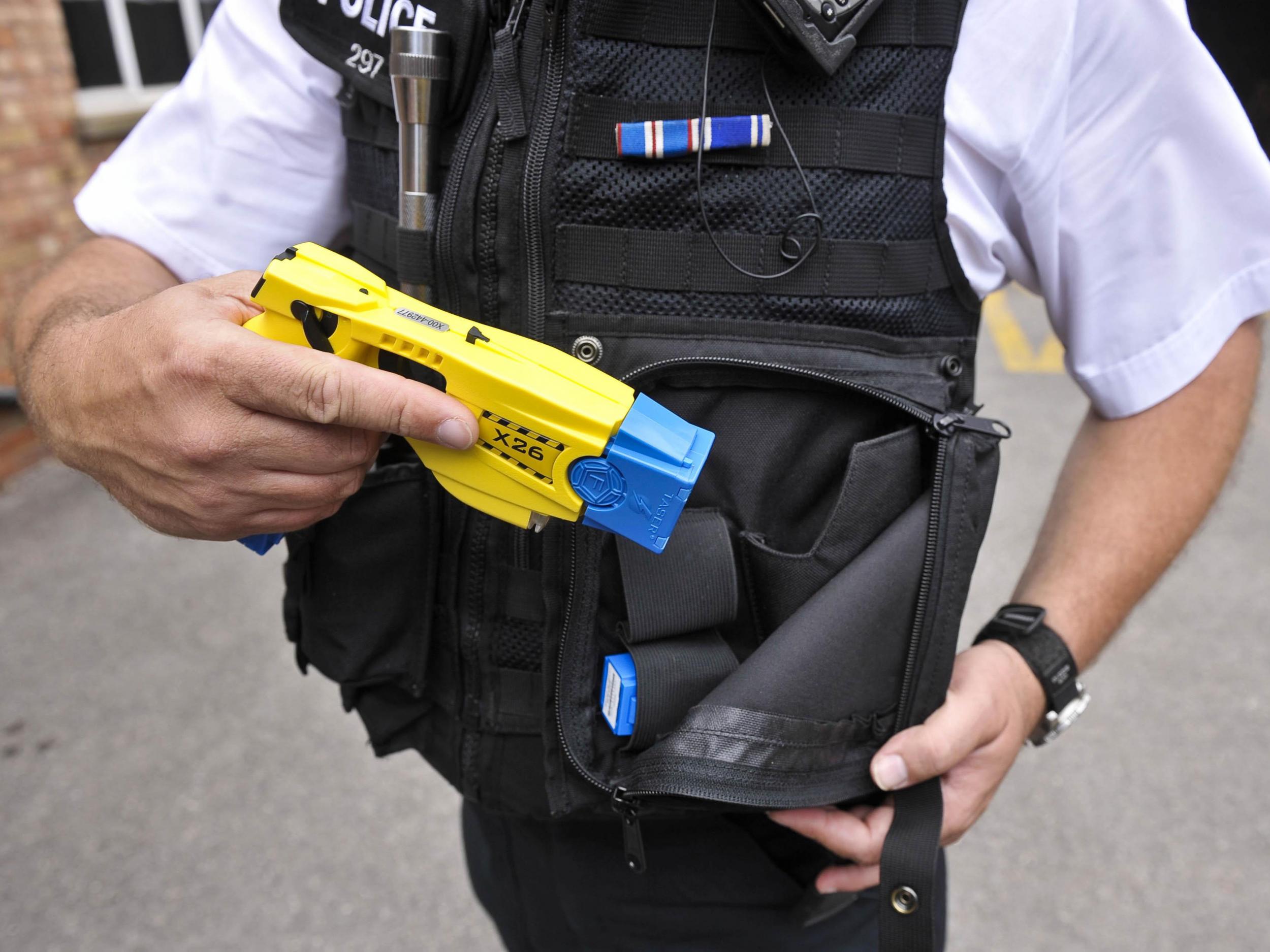 An officer holsters a Taser X26 during a training exercise