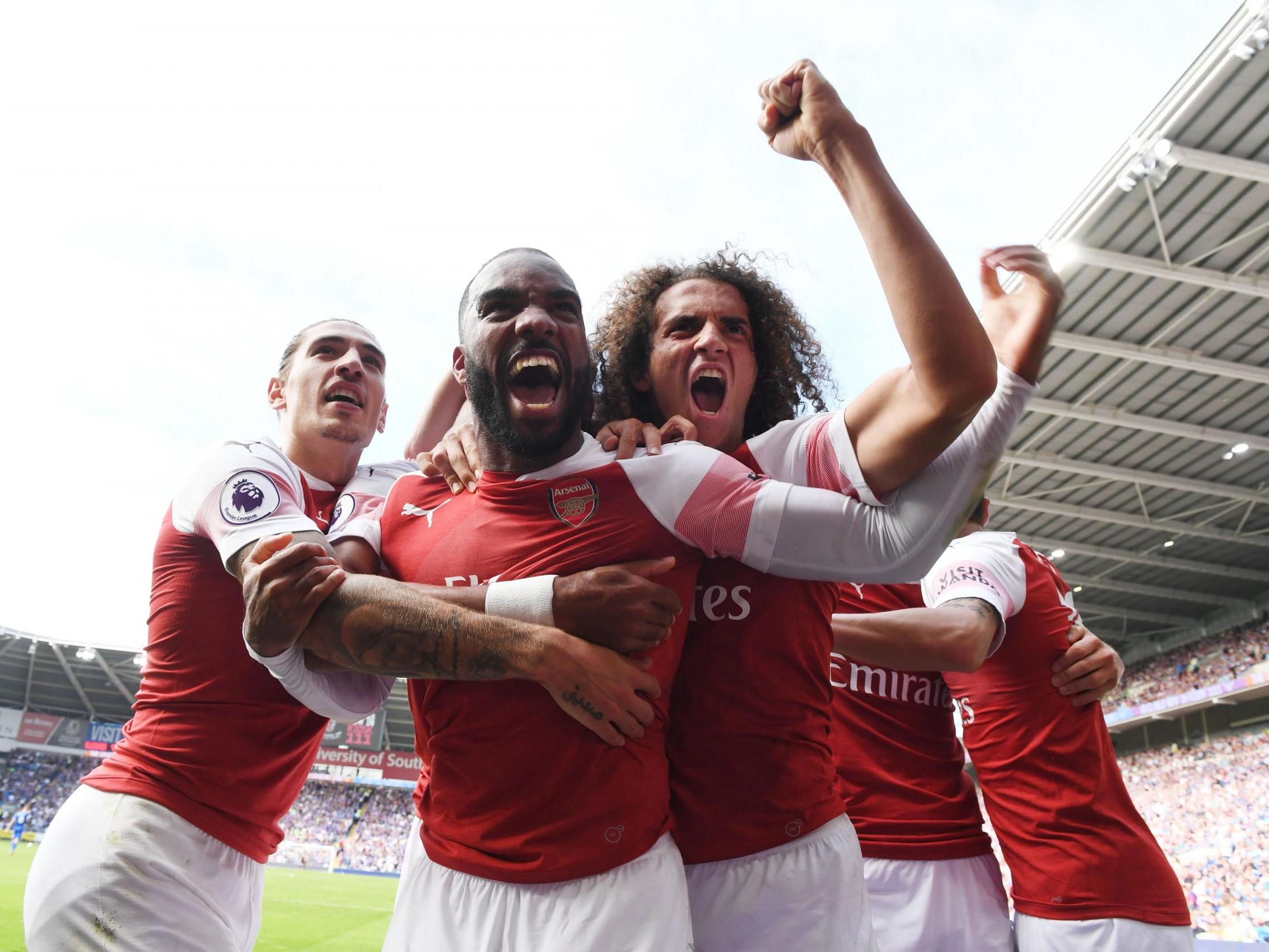 Alexandre Lacazette celebrates with his team mates after hitting the winning goal