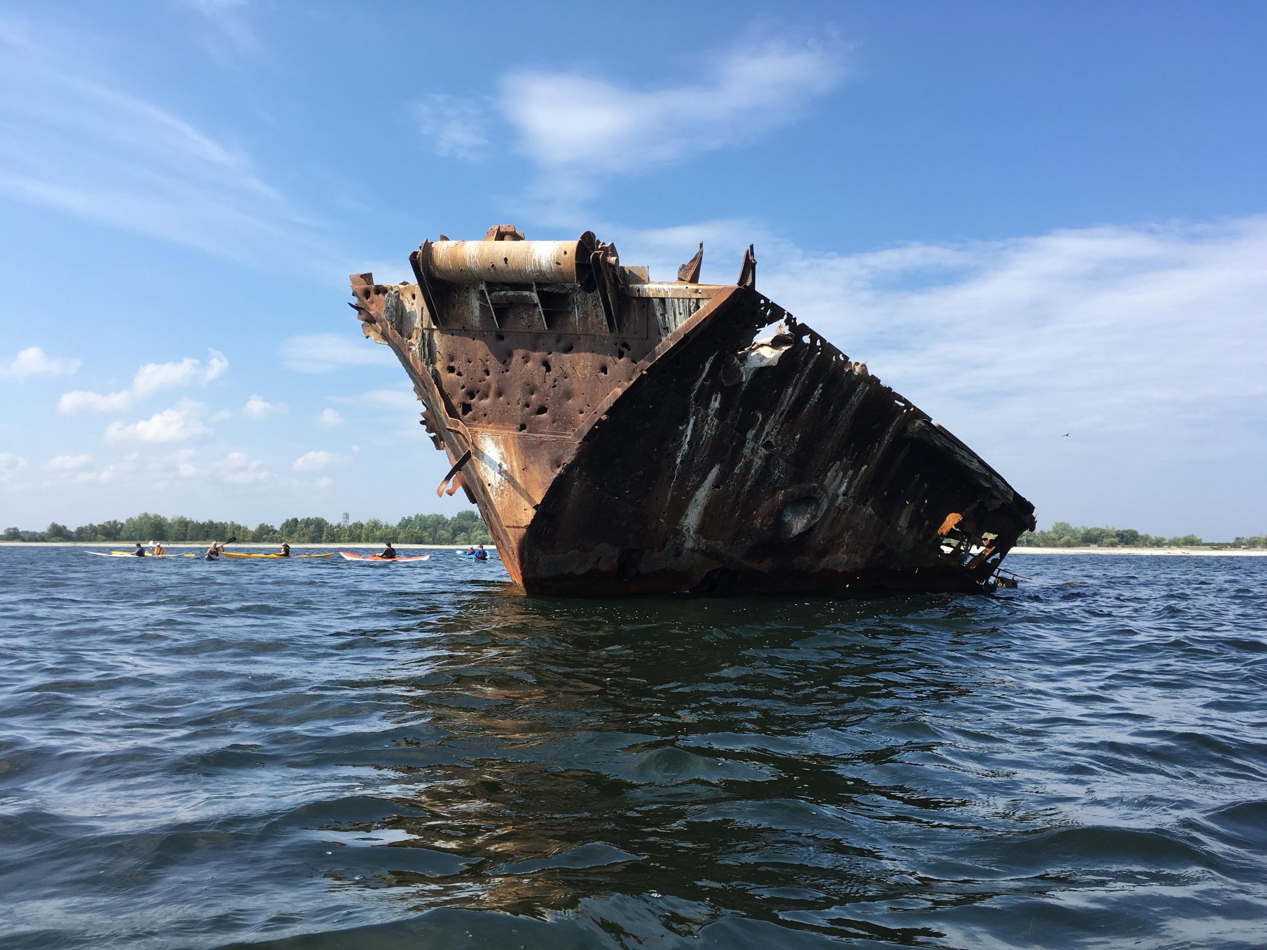 A rusting decommissioned Soviet-era boat juts out of the Baltic Sea