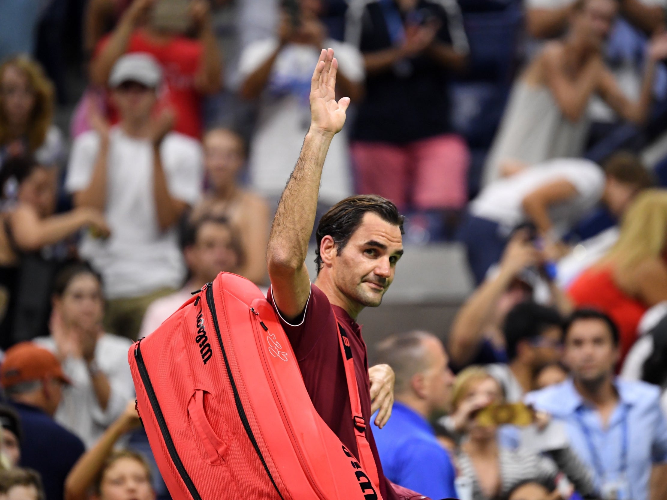 Roger Federer waves goodbye to the crowd after his fourth-round exit