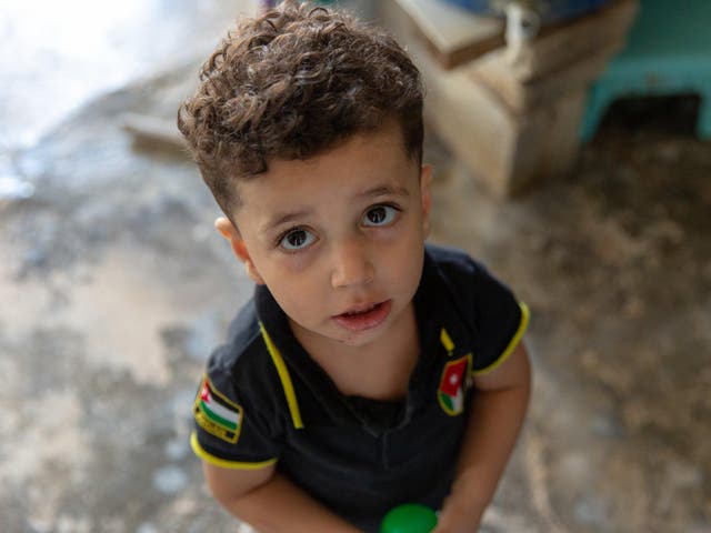 Syrian refugee Rula plays with her nephew at their family home in Al-Zaatari refugee camp in the Jordanian city of Mafraq, near the border with Syria, August 7, 2018