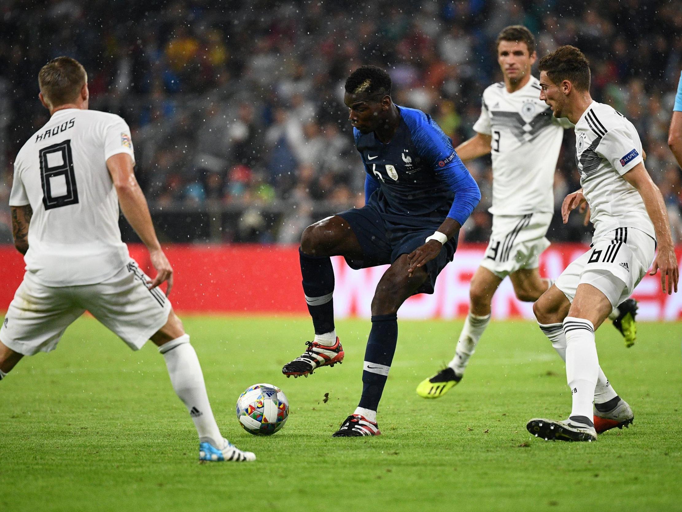 Paul Pogba finds himself surrounded by a group of German players