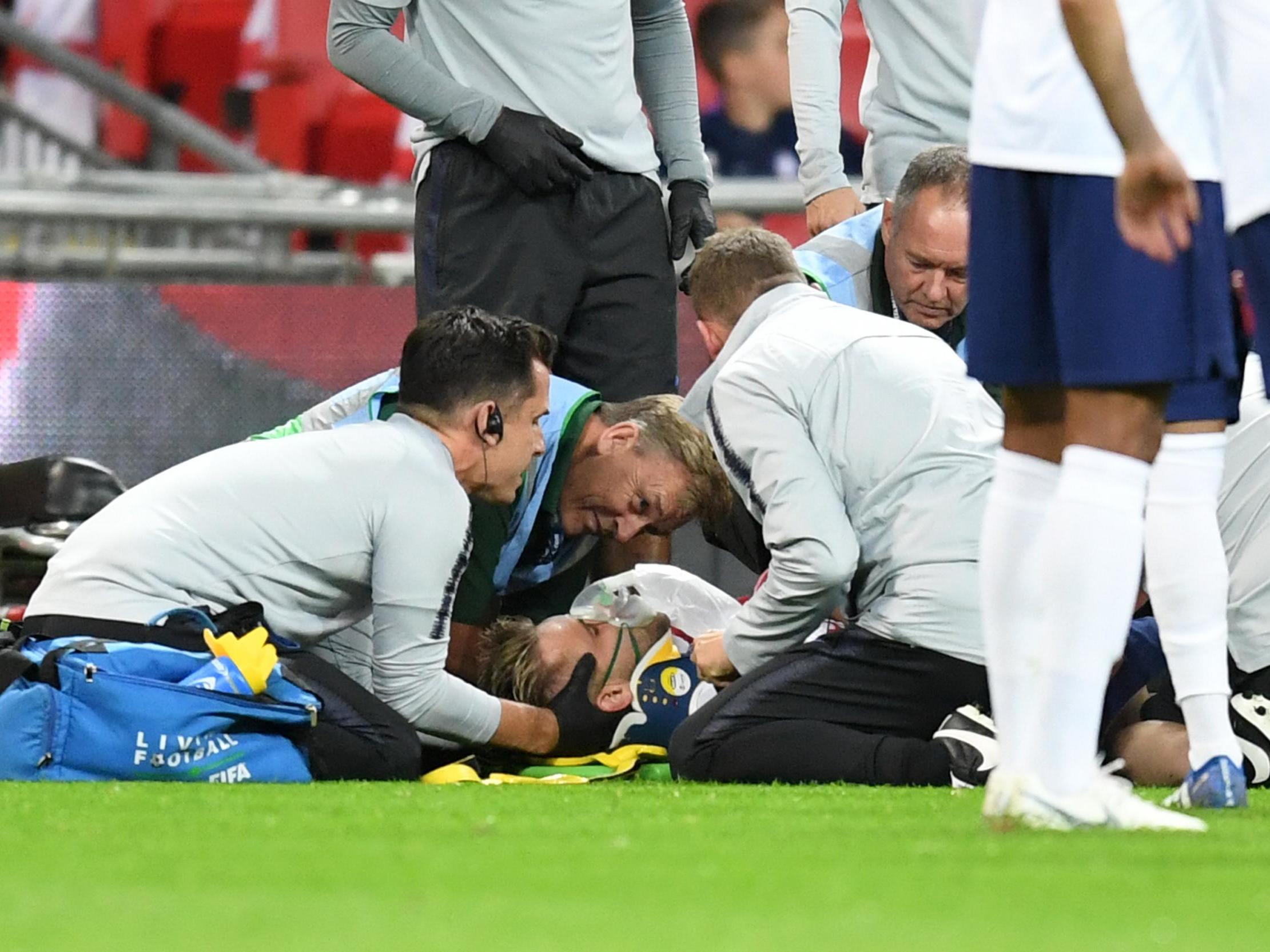 Luke Shaw receives on-pitch treatment following his collision with Dani Carvajal