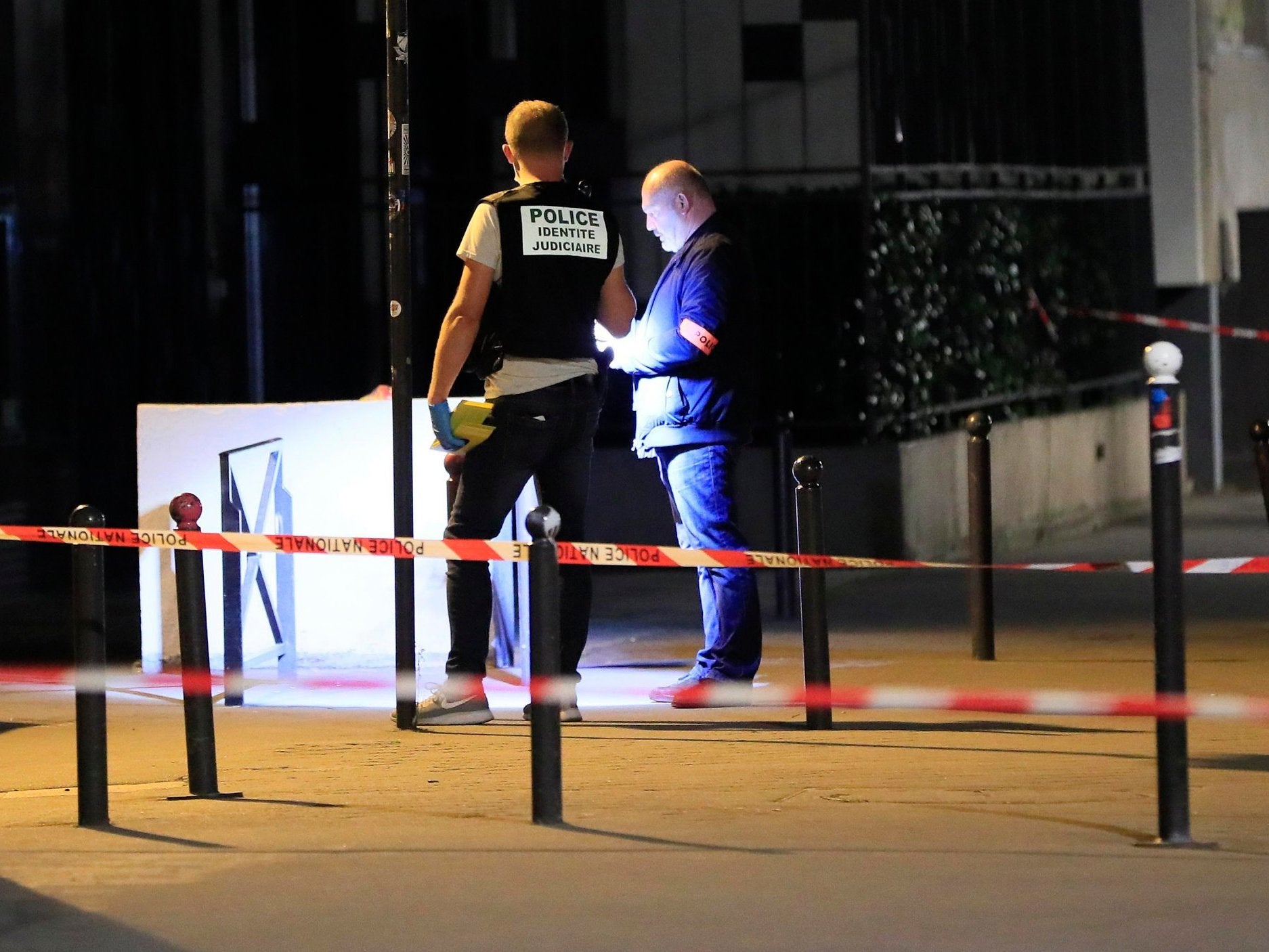 Police investigators work on the scene after seven people were wounded in knife attack in Paris, 10 September