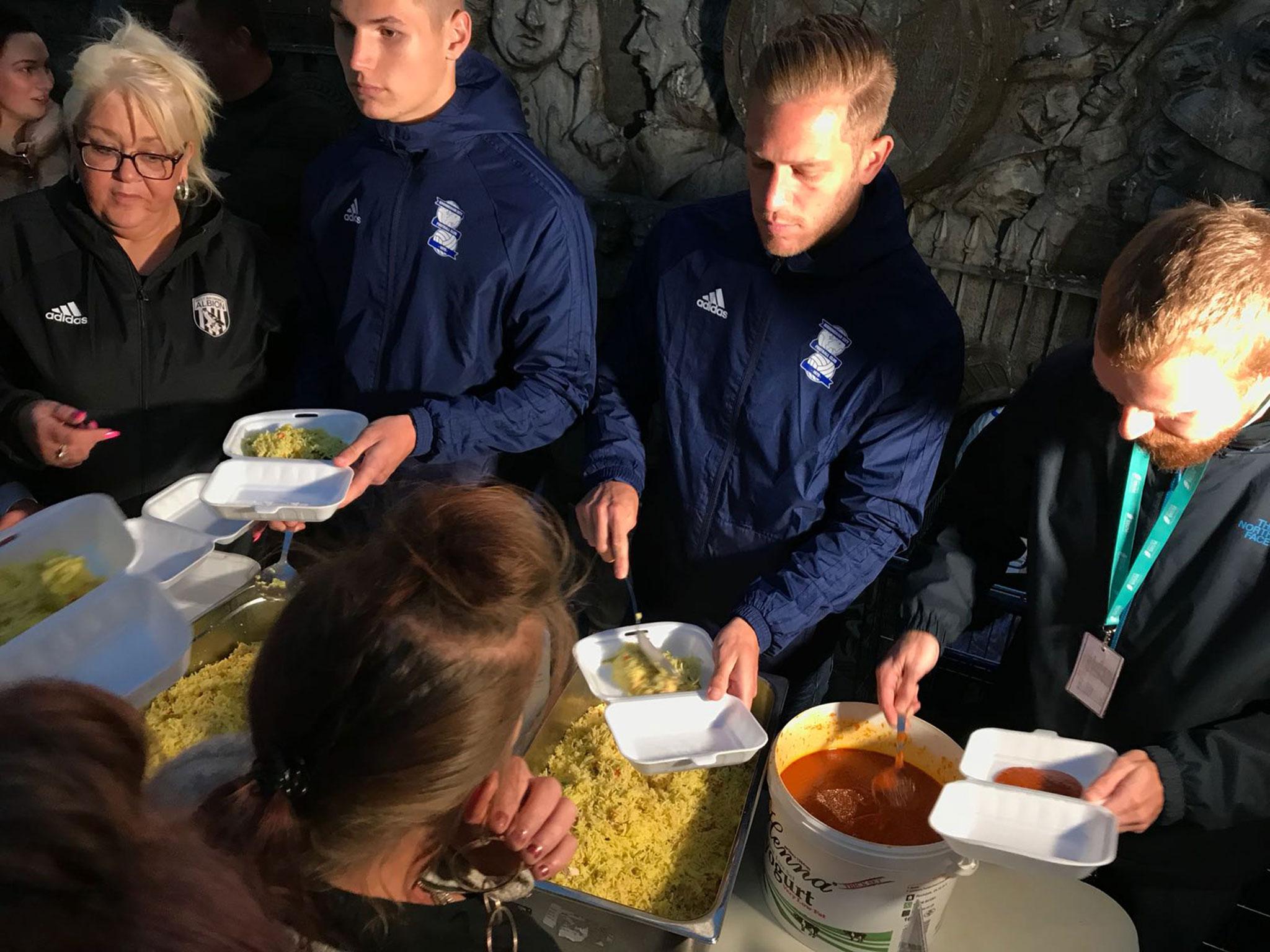 Players from Birmingham City help serve food to the homeless as part of the Foundation's work.