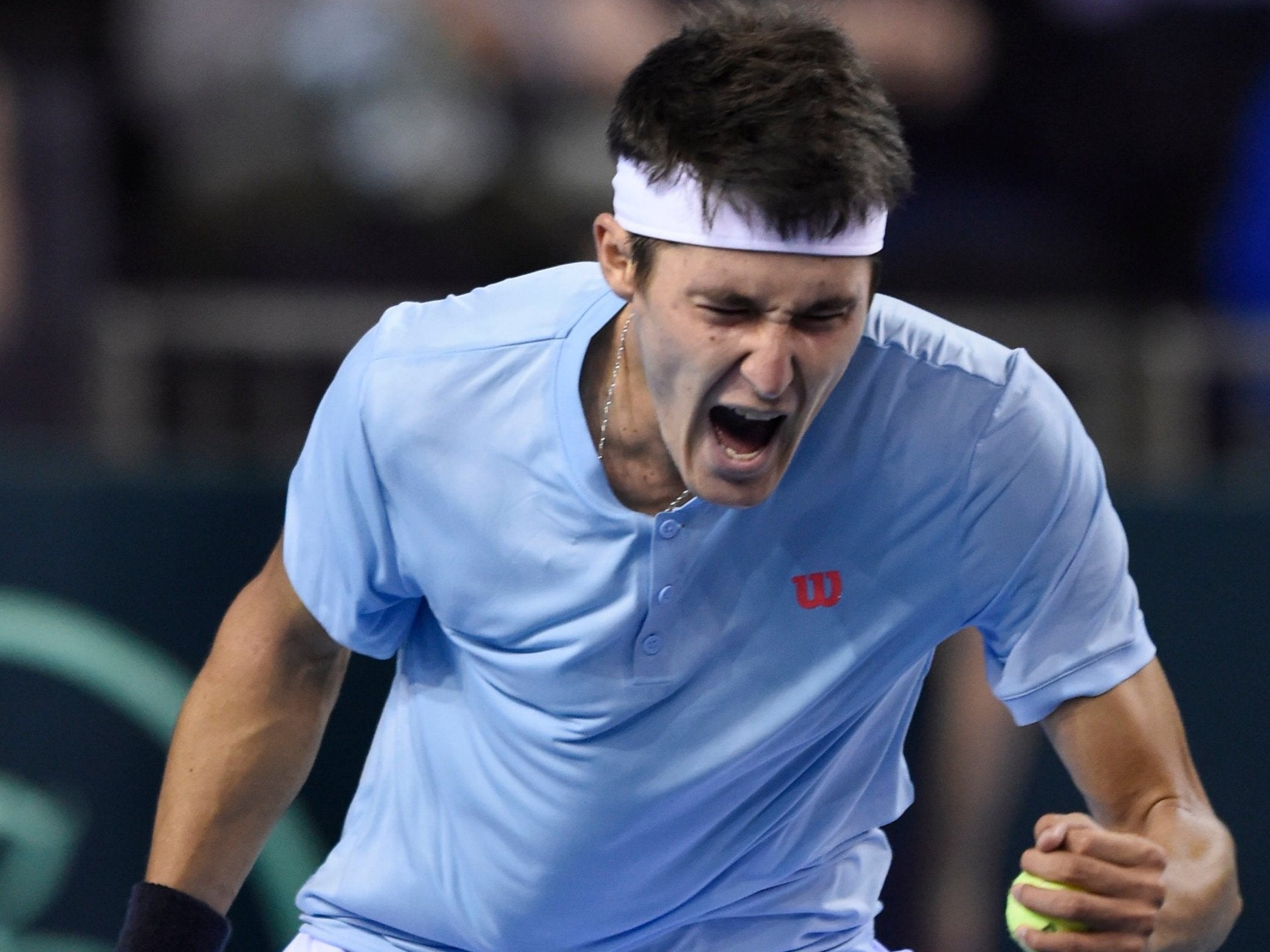 Jurabek Karimov celebrates beating Britain's Cameron Norrie